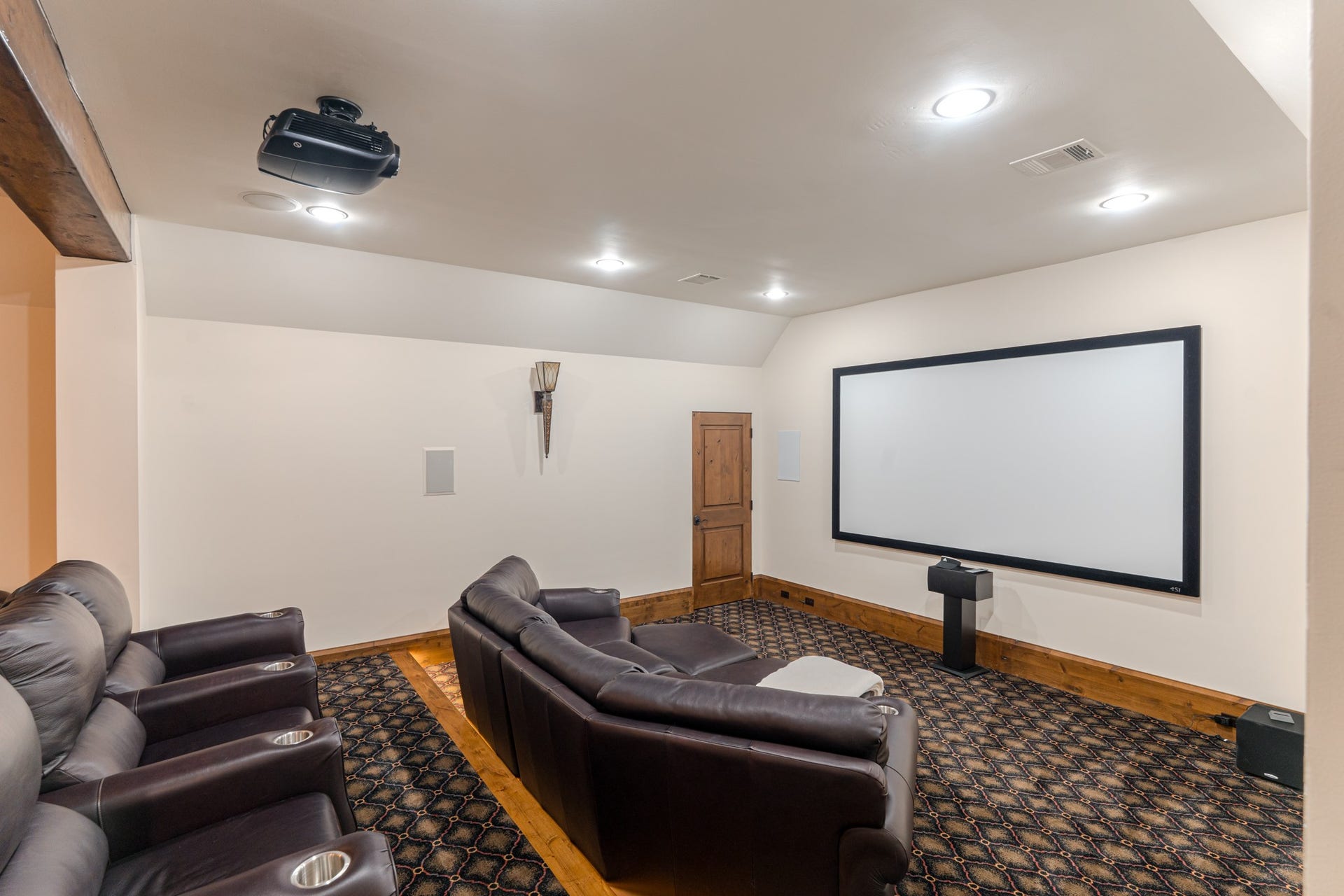 247 S Fazio Way, Spring, TX 77389 Home theatre with projector , oversized screen, and tiered seating, perfect for movie nights, sporting events, and immersive entertainment.