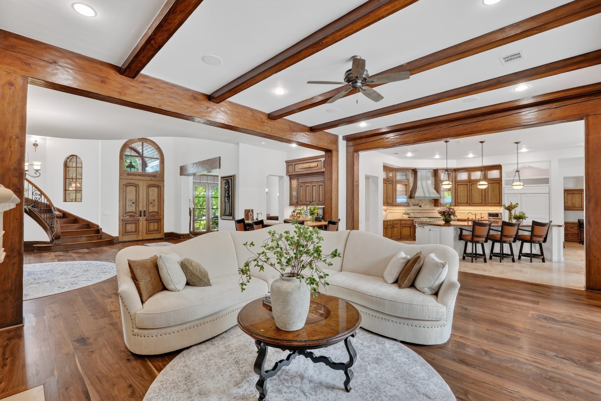 247 S Fazio Way, Spring, TX 77389 Spacious family room showcasing a seamless open-concept design, connecting the grand entry, entertaining bar, wine cellar, and gourmet kitchen.