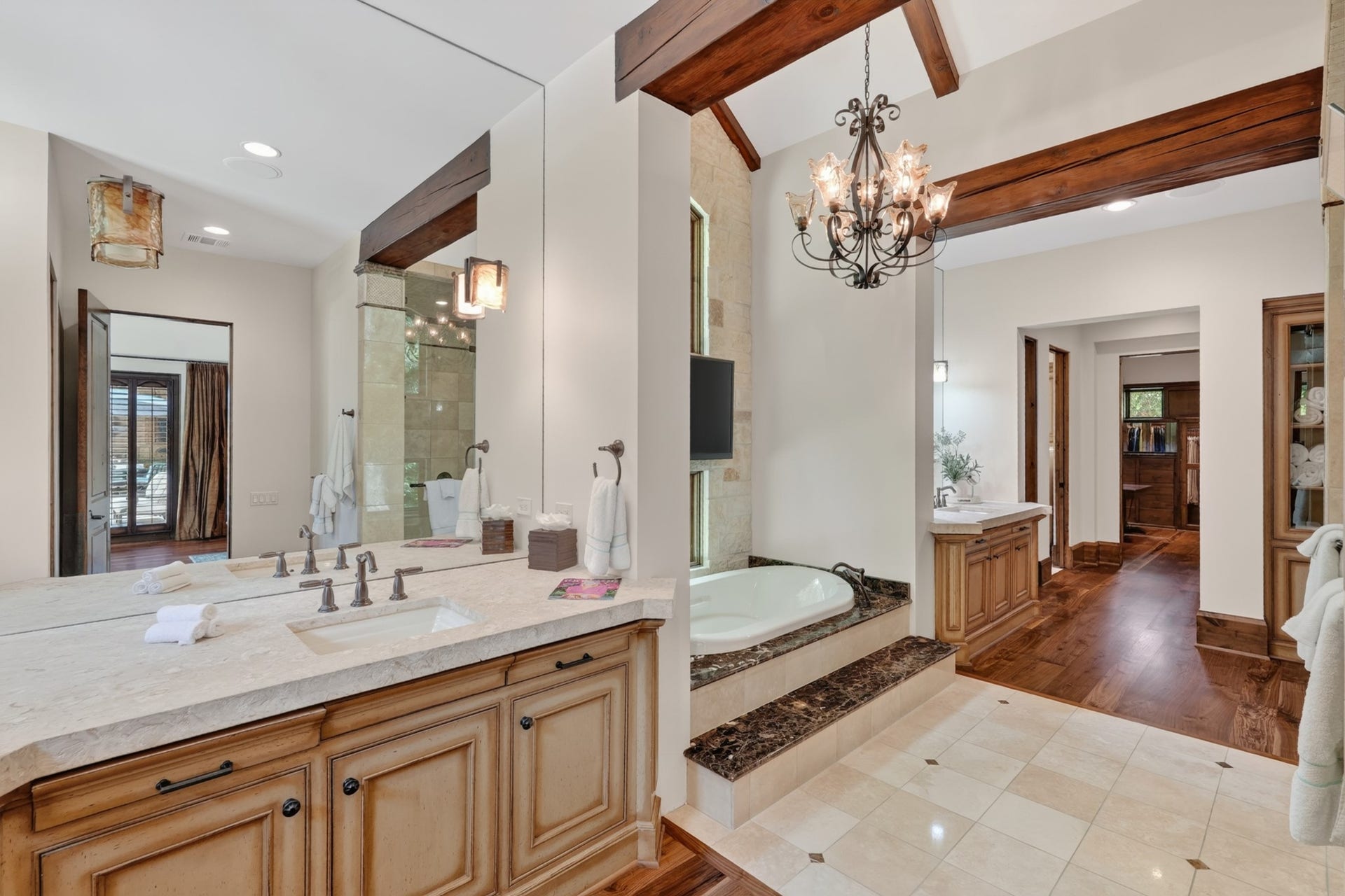 247 S Fazio Way, Spring, TX 77389 Spa-inspired primary bathroom featuring heated floor, dual vanities, a soaking tub, with elegant finishes and generous storing throughout.