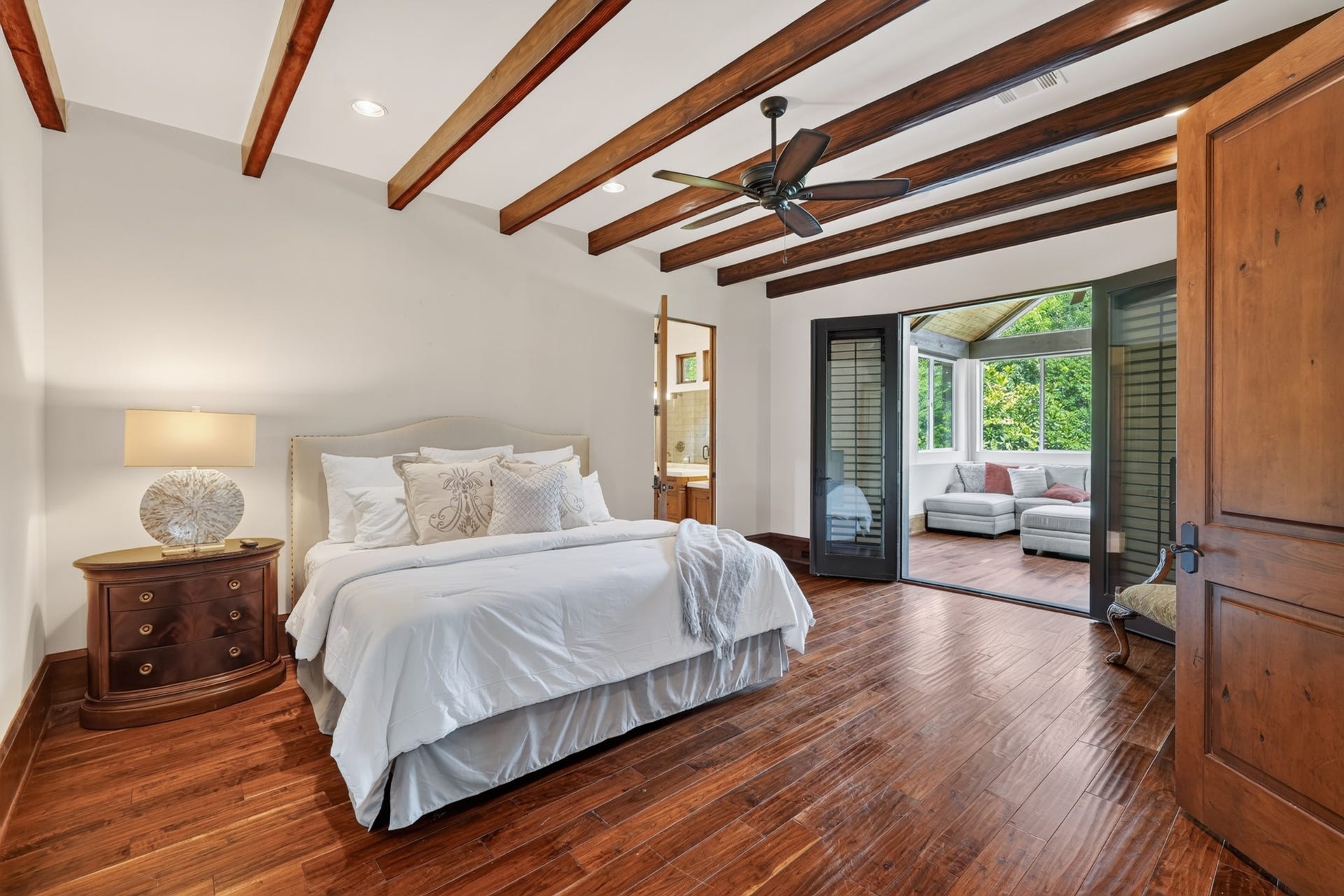 247 S Fazio Way, Spring, TX 77389 Spacious secondary bedroom with an en suite bathroom and direct access to the covered patio area, providing a unique space.