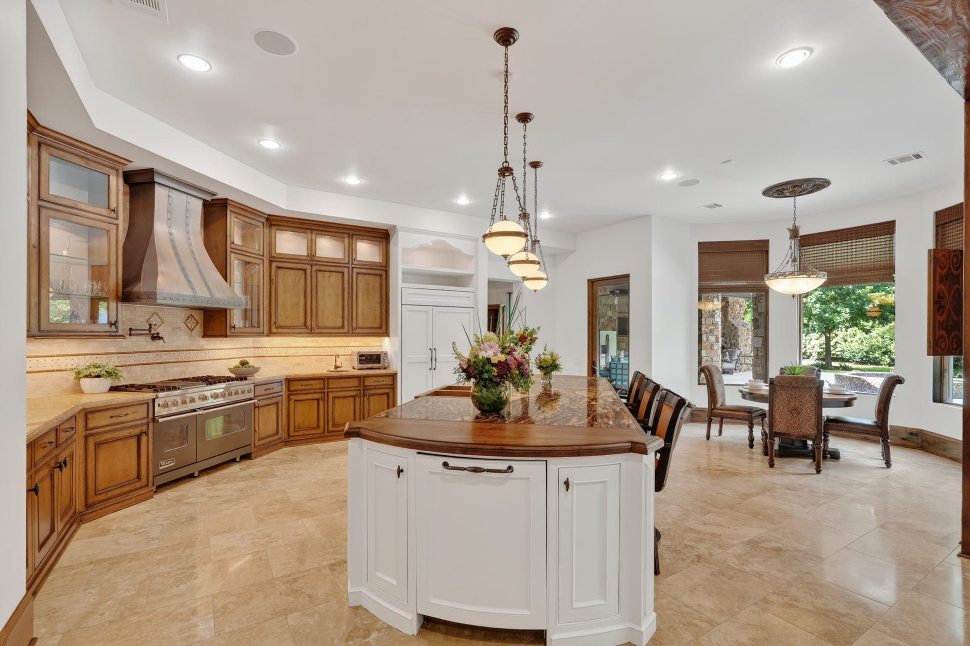 247 S Fazio Way, Spring, TX 77389 The gourmet chef's kitchen features premium top stainless steel appliances, custom cabinetry, and oversized island with seating, and a sunny breakfast area overlooking the backyard.