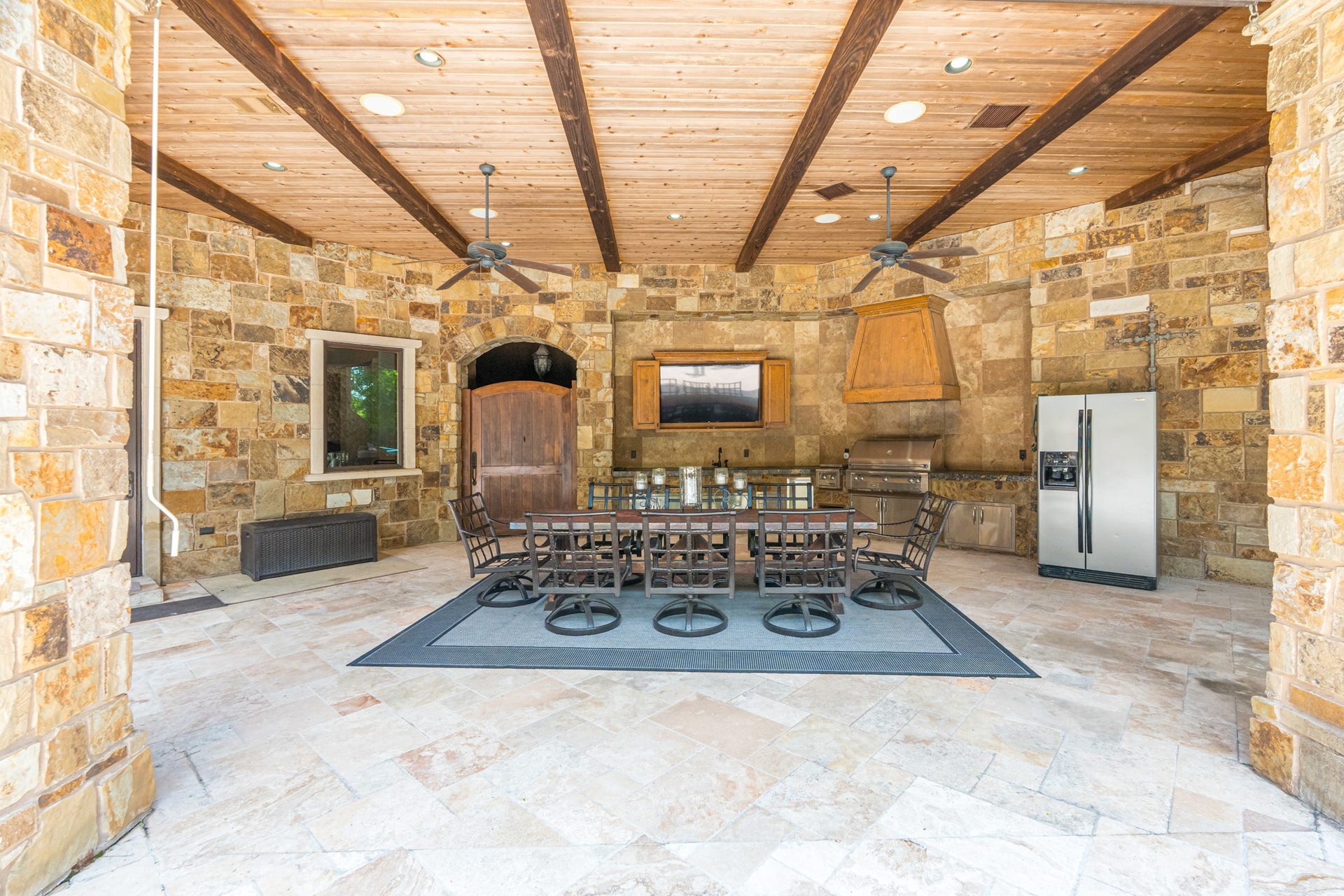 247 S Fazio Way, Spring, TX 77389 An entertainer's dream, this extensive covered pavilion features a fully equipped outdoor kitchen, dining area, soaring wood-beamed ceilings, and ample space for hosting family and friends year-round.