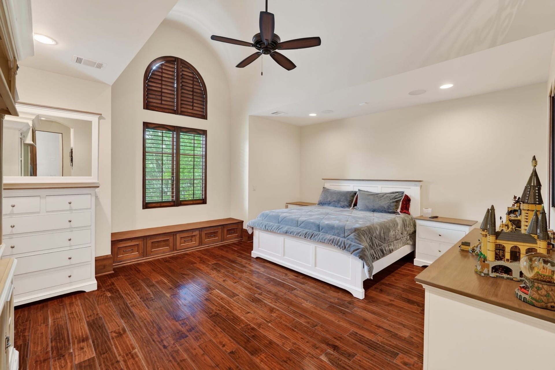 247 S Fazio Way, Spring, TX 77389 Generously sized secondary bedroom features soaring vaulted ceilings, custom plantation shutters, built-in window seating and abundant natural light.