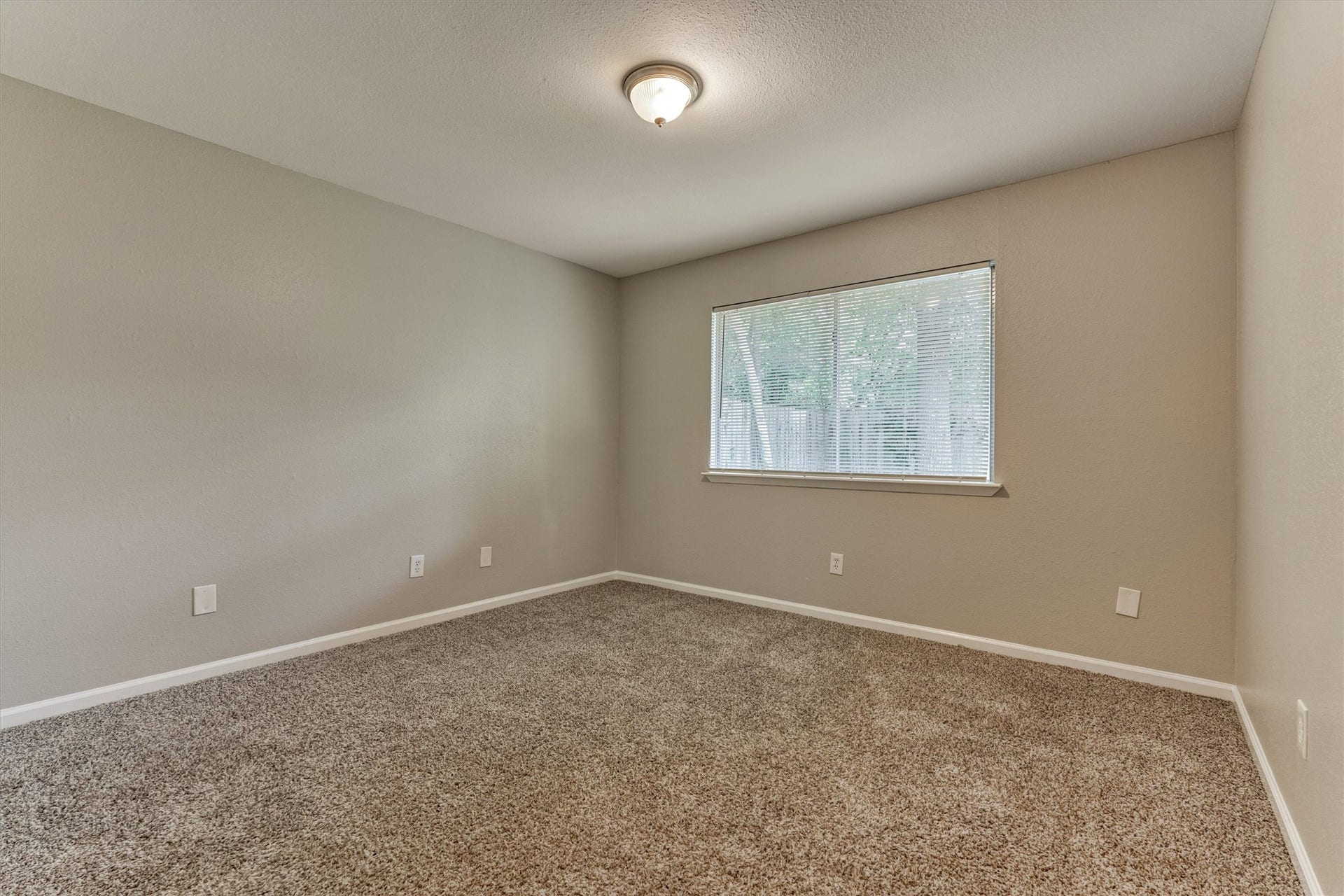 26 W Broken Oak Court, The Woodlands, TX 77381 This secondary bedroom is also located on the back of the home.