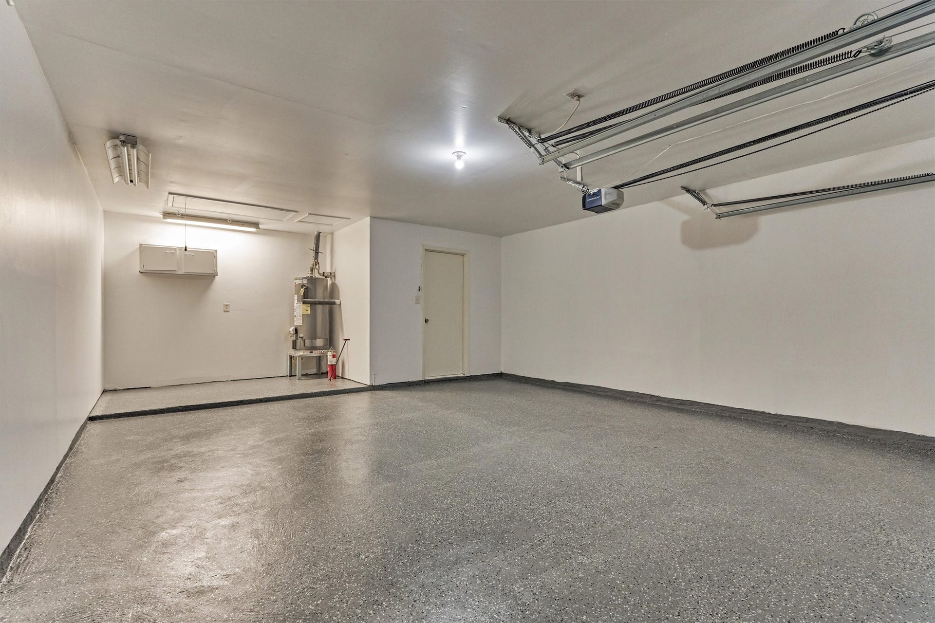 26 W Broken Oak Court, The Woodlands, TX 77381 The additional length on the left side of the garage is ideal for a work bench or lawn equipment storage.
