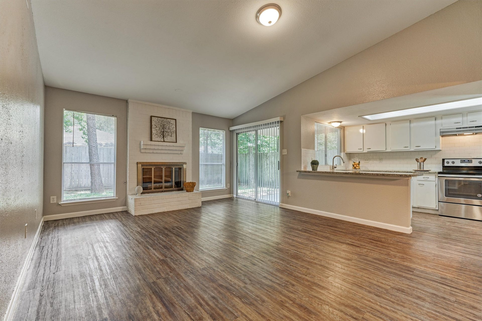 26 W Broken Oak Court, The Woodlands, TX 77381 The sliding glass door provides convenient access to the covered porch and back yard.