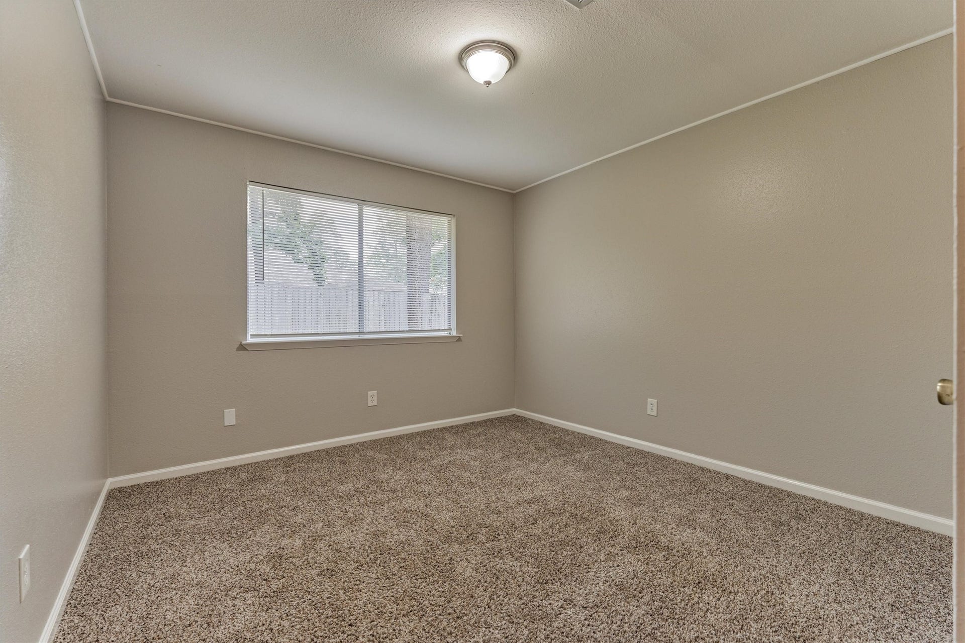 26 W Broken Oak Court, The Woodlands, TX 77381 One of two secondary bedrooms, located on the back of the home.