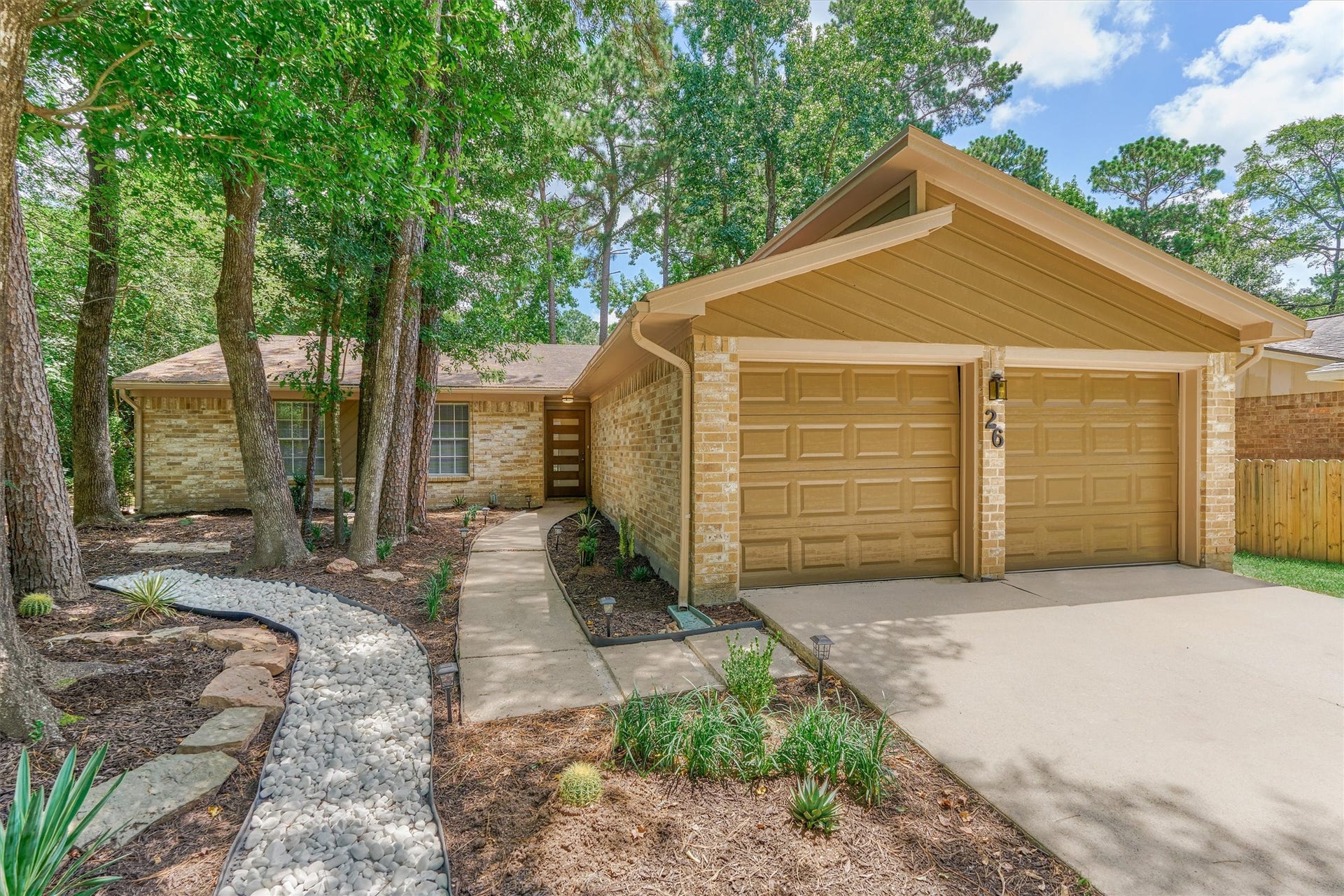 26 W Broken Oak Court, The Woodlands, TX 77381 A full gutter system surrounds the home.