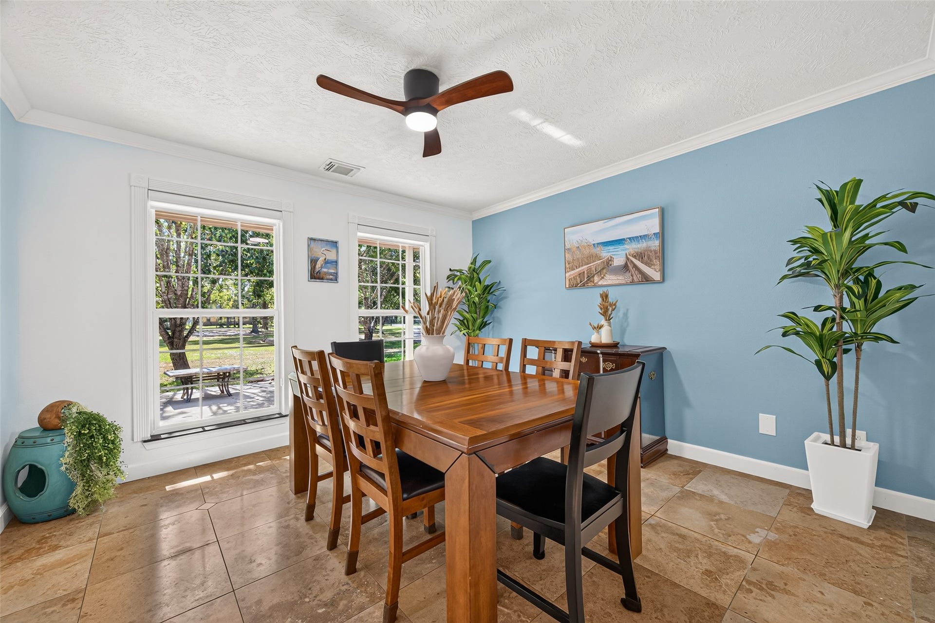 Dining area with tile flooring, plenty of natural light and views of the surrounding property.