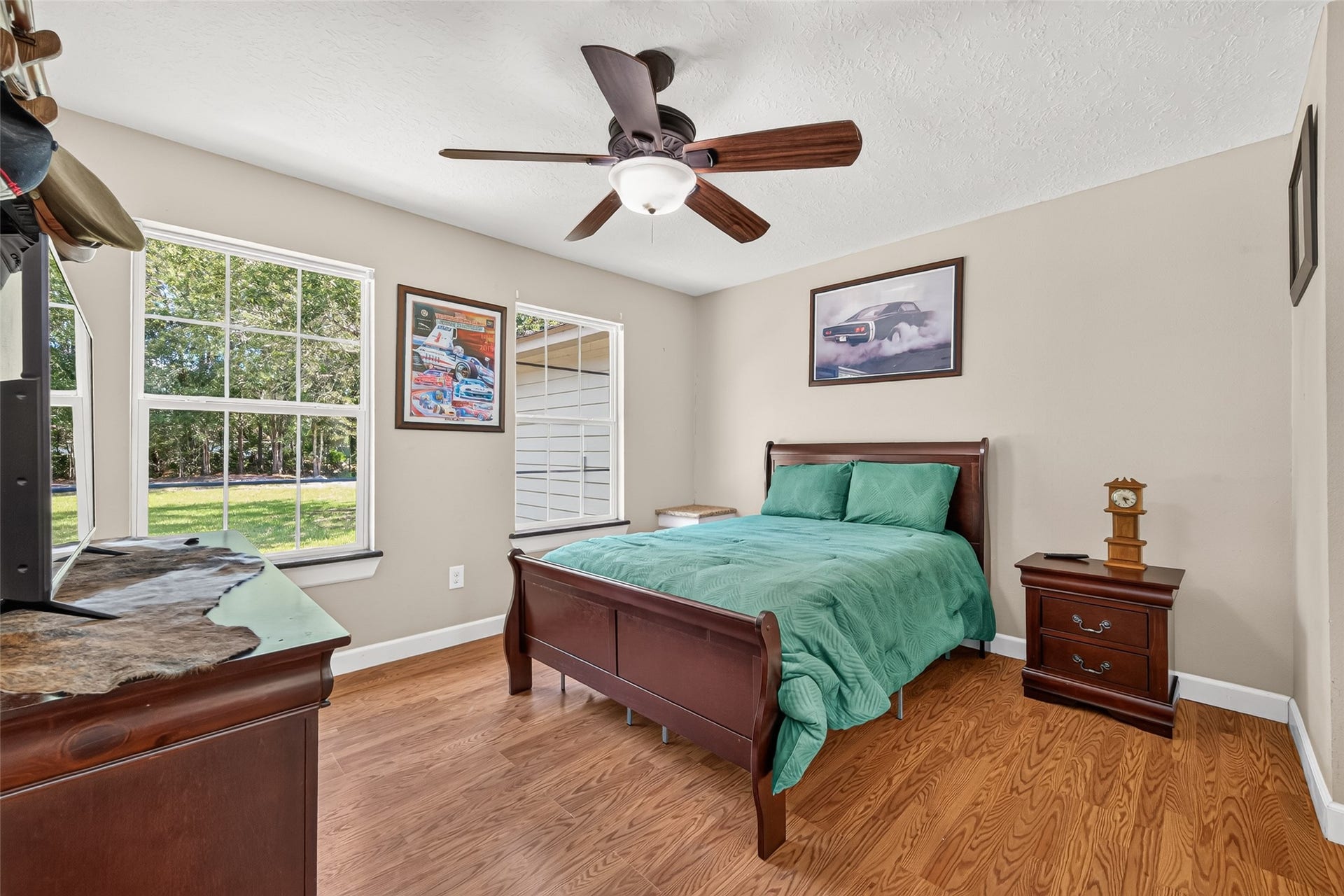 Additional secondary bedroom with two large windows, wood flooring and plenty of natural light.