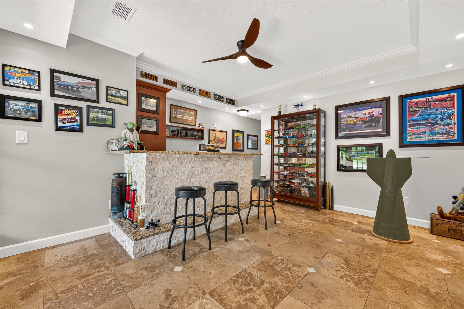 Spacious game room with a built-in bar area, granite countertop and plenty of room for games, seating and entertaining.