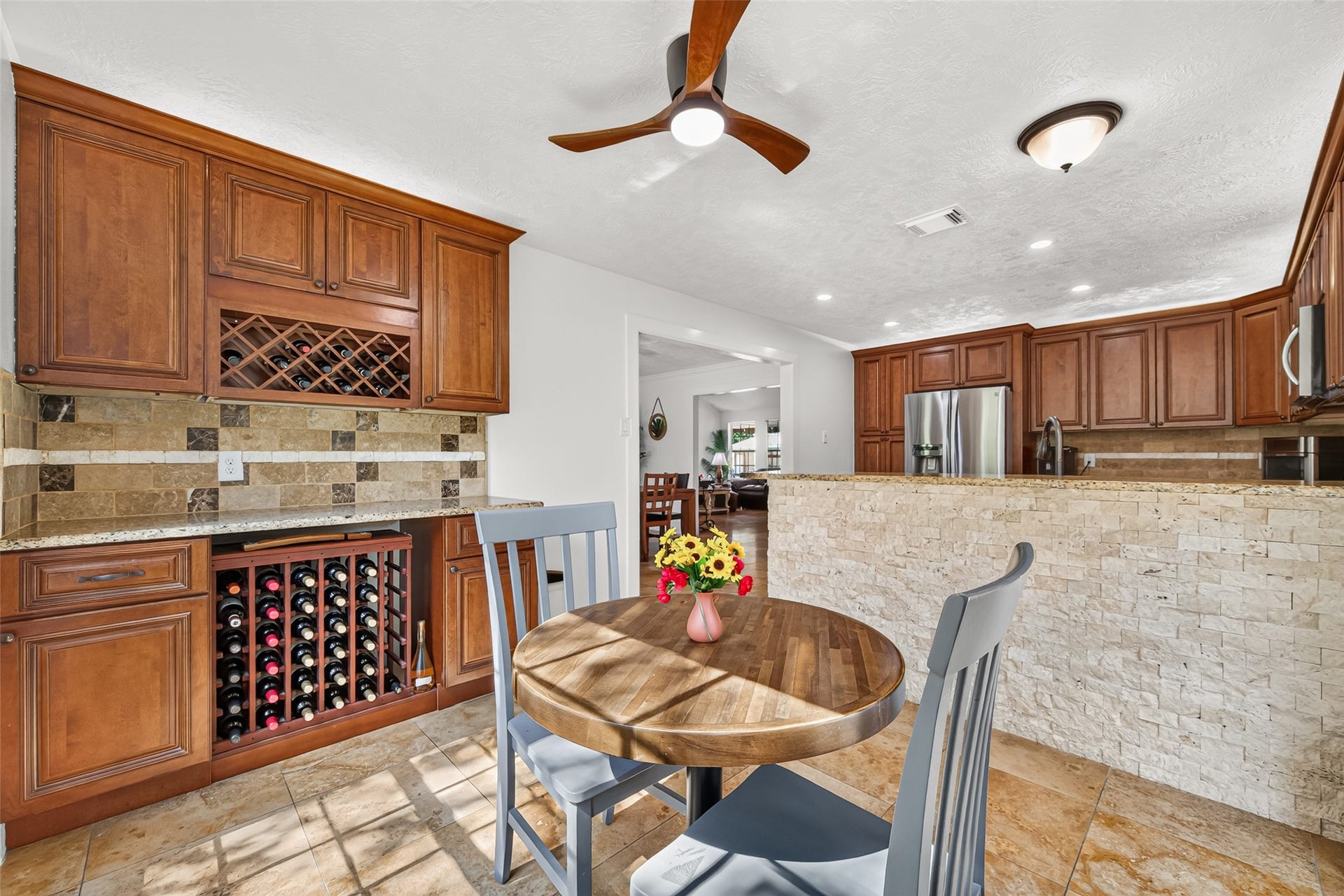 Breakfast area flows directly into the kitchen and features built-in cabinetry with wine storage.