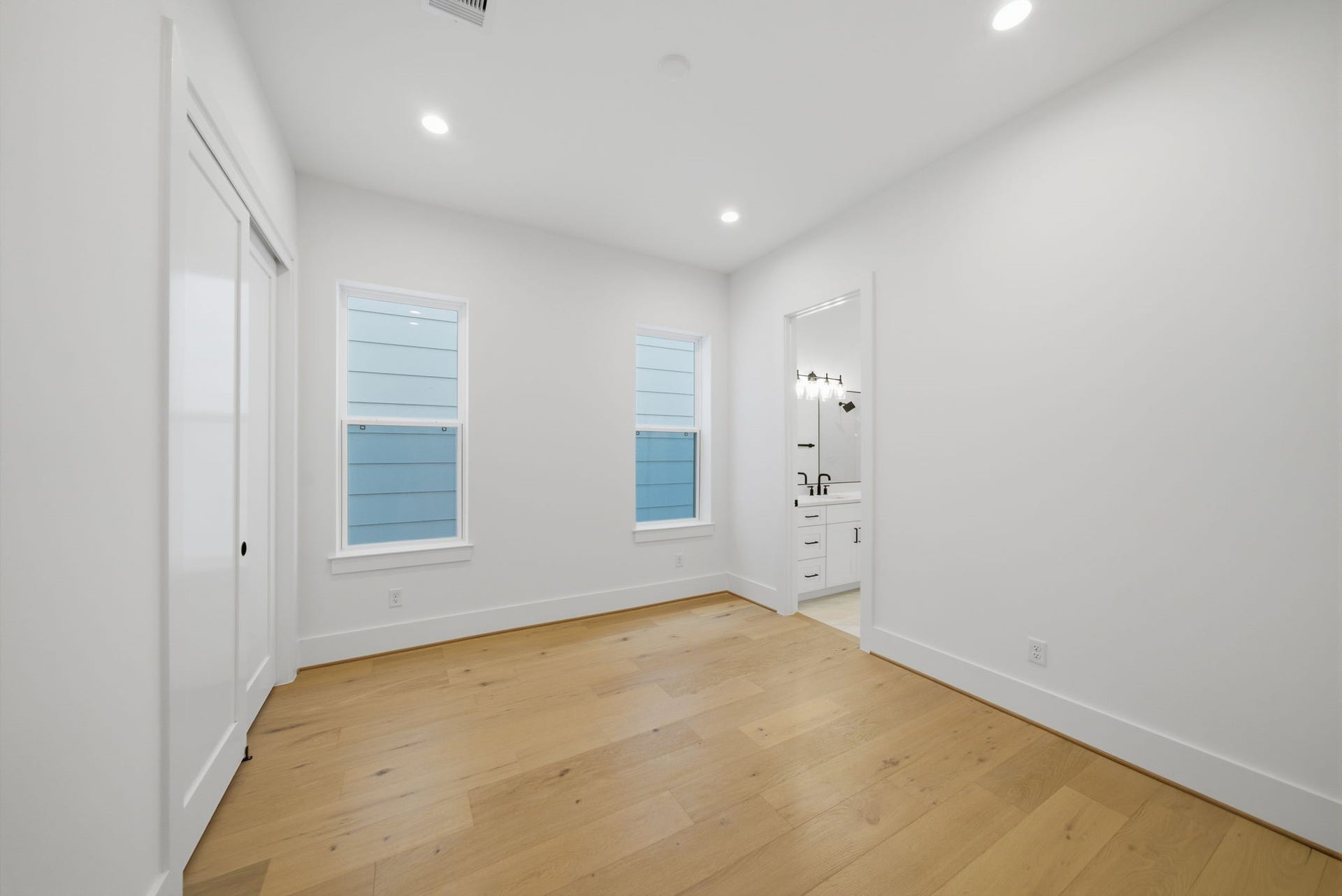 another view of one of the sizable guest bedrooms with large closet and adjoining bath.