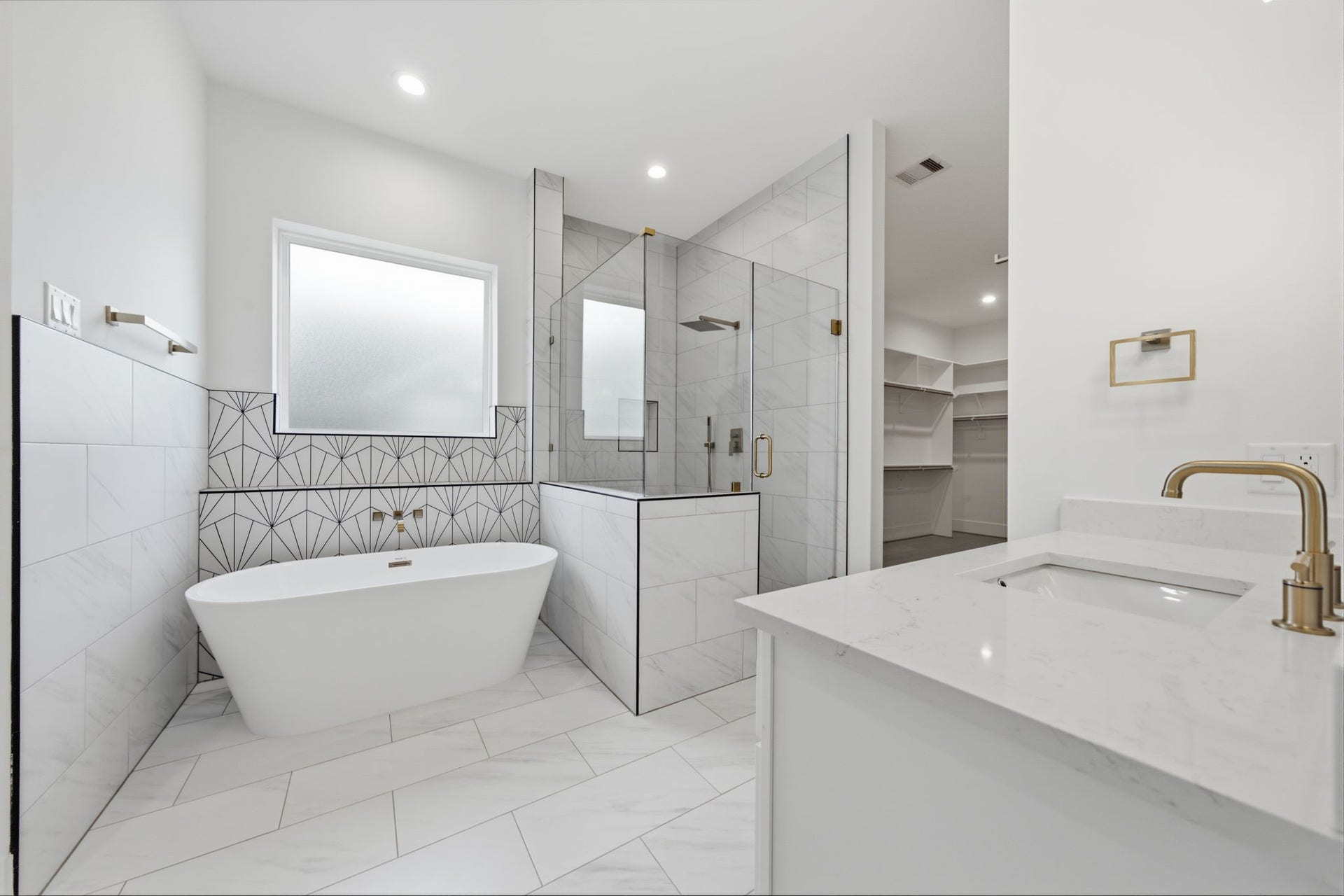 Lovely freestanding soaking tub with decorative tile.