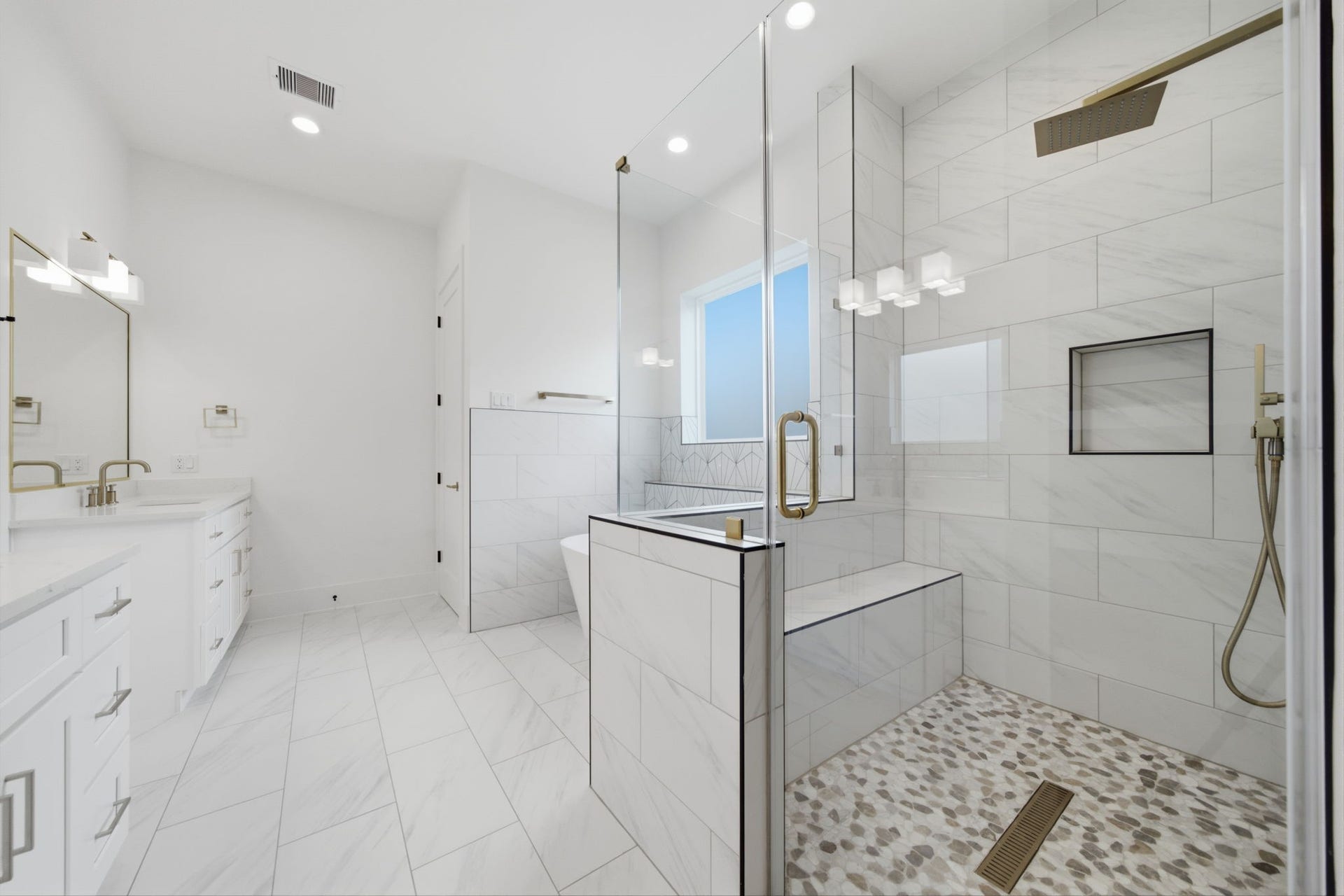 tylish primary bath with high-end finishes and a freestanding soaking tub.