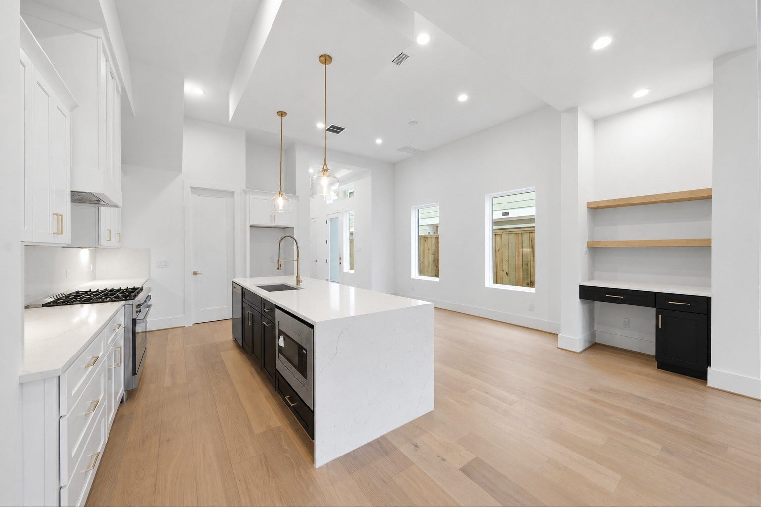 Chef's kitchen with modern open feel highlighted by Bosch appliance package all around and build in desk area