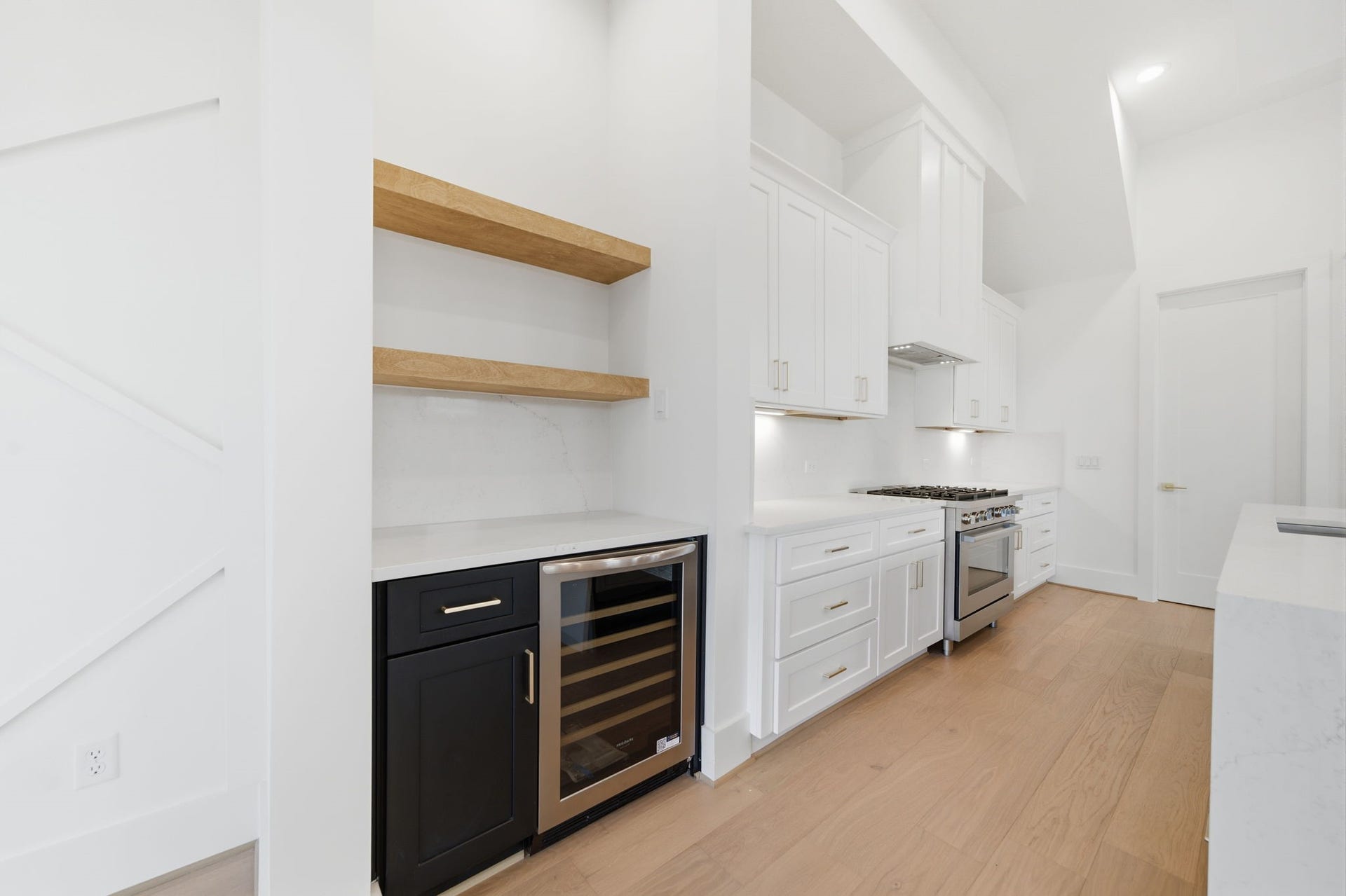 Dry bar and wine fridge are perfectly situated between the living and kitchen areas. Perfect for entertaining!