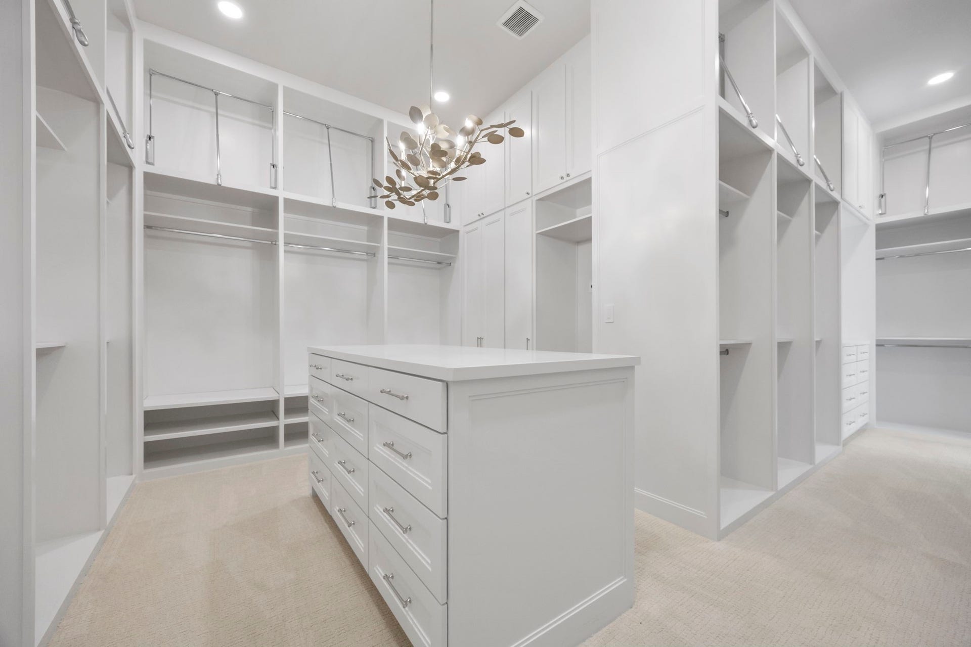 4233 Two Gun Way, Katy, TX 77494 Wonderfully oversized primary closet with packing island and gold and crystal accented chandelier.