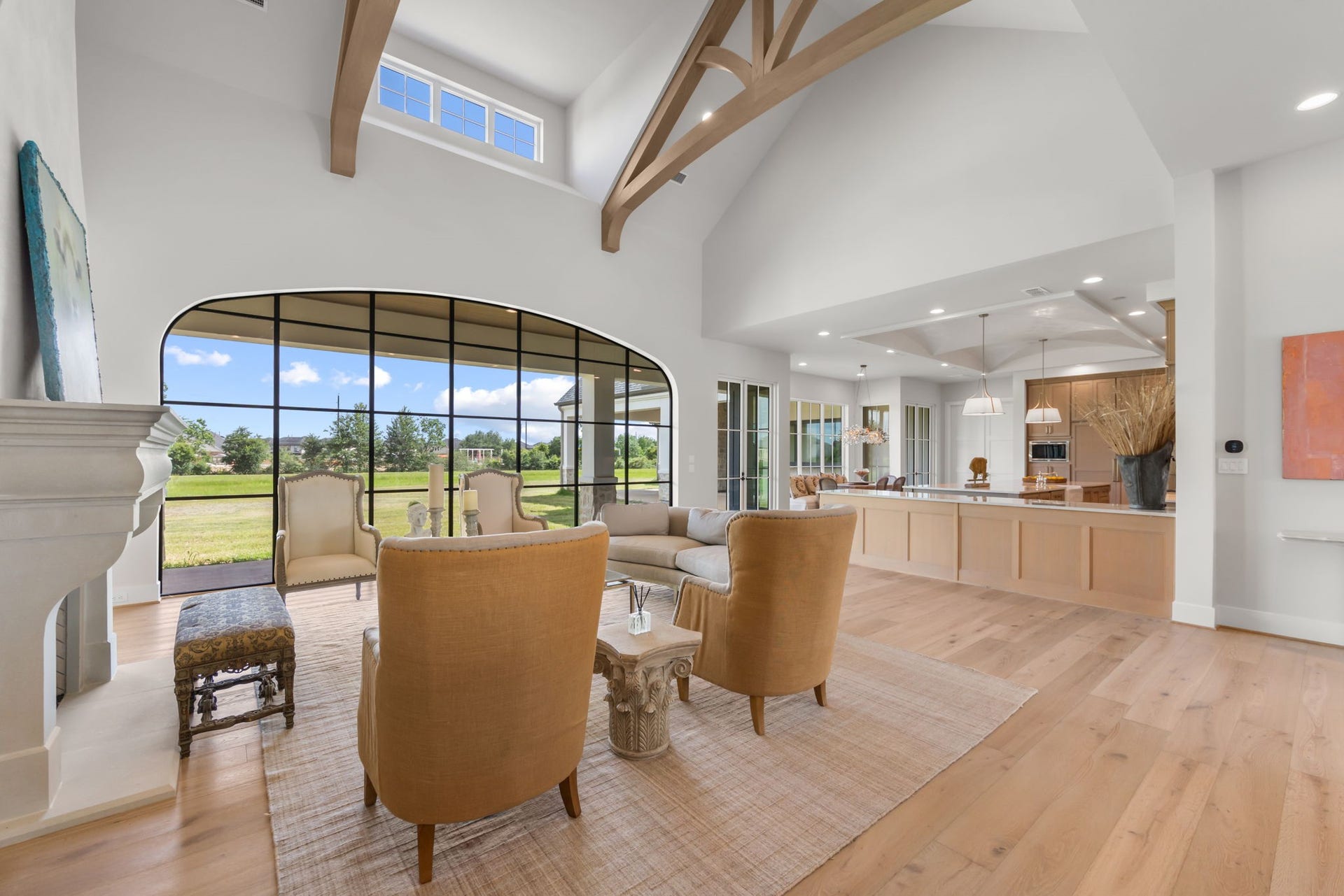 4233 Two Gun Way, Katy, TX 77494 Beautiful view of living room with wall of windows, dormer windows, beamed ceiling and open to large island kitchen with beautiful breakfast room/informal dining with wall of windows.