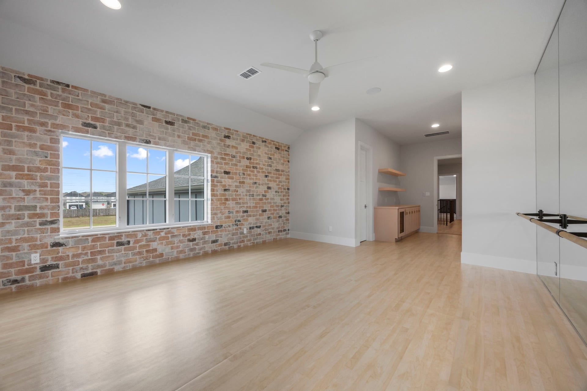 4233 Two Gun Way, Katy, TX 77494 Upstairs ballet/dance studio with brick wall, across from wall of mirrors with ballet bar. This could also be an 8th bedroom with large closet.