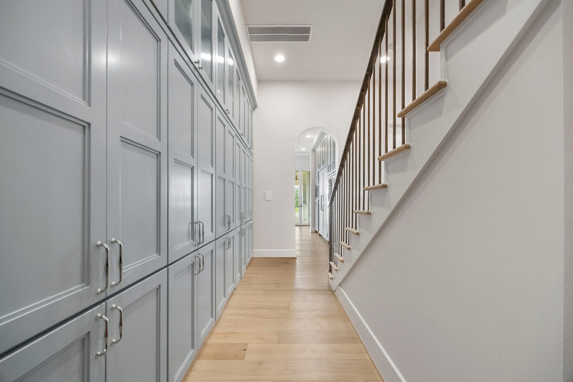 4233 Two Gun Way, Katy, TX 77494 Walk out of your stunning kitchen to rear hall staircase and a large wall of storage cabinets in front of your walk-in panty.