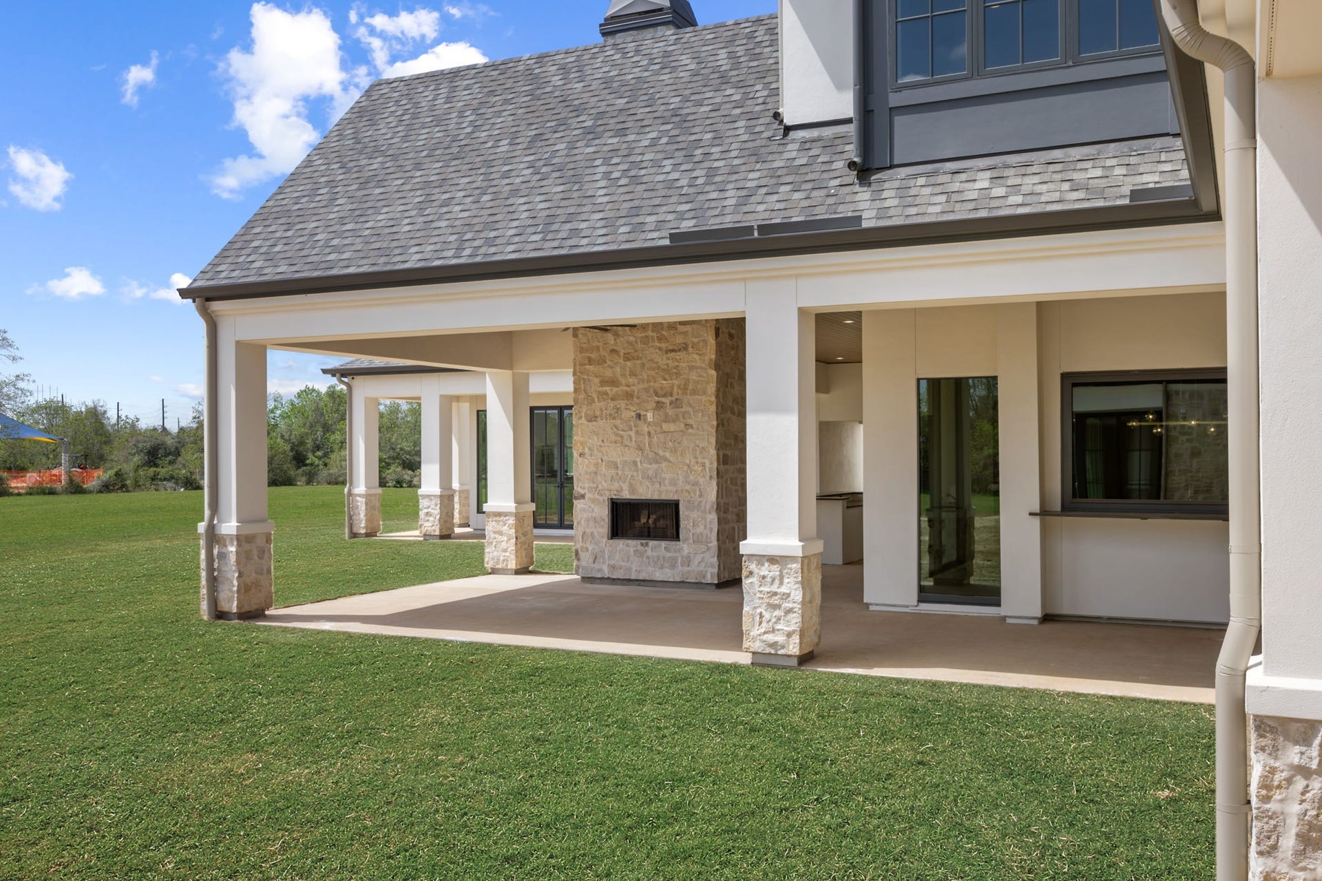 4233 Two Gun Way, Katy, TX 77494 View of rear loggia with fireplace and sitting area. That is the serving vindow that opens awning style from the bar in the game room.