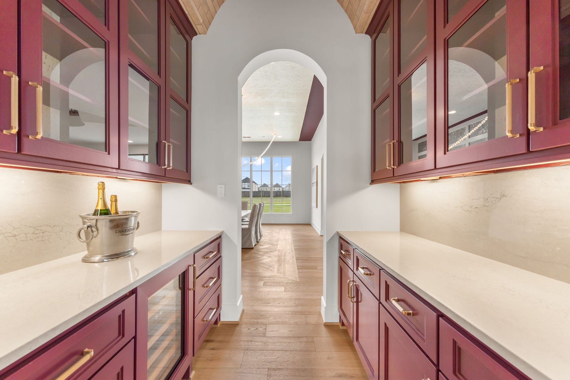 4233 Two Gun Way, Katy, TX 77494 Dramatic butler's pantry with brick barrel ceiling and rich crimson cabinets.