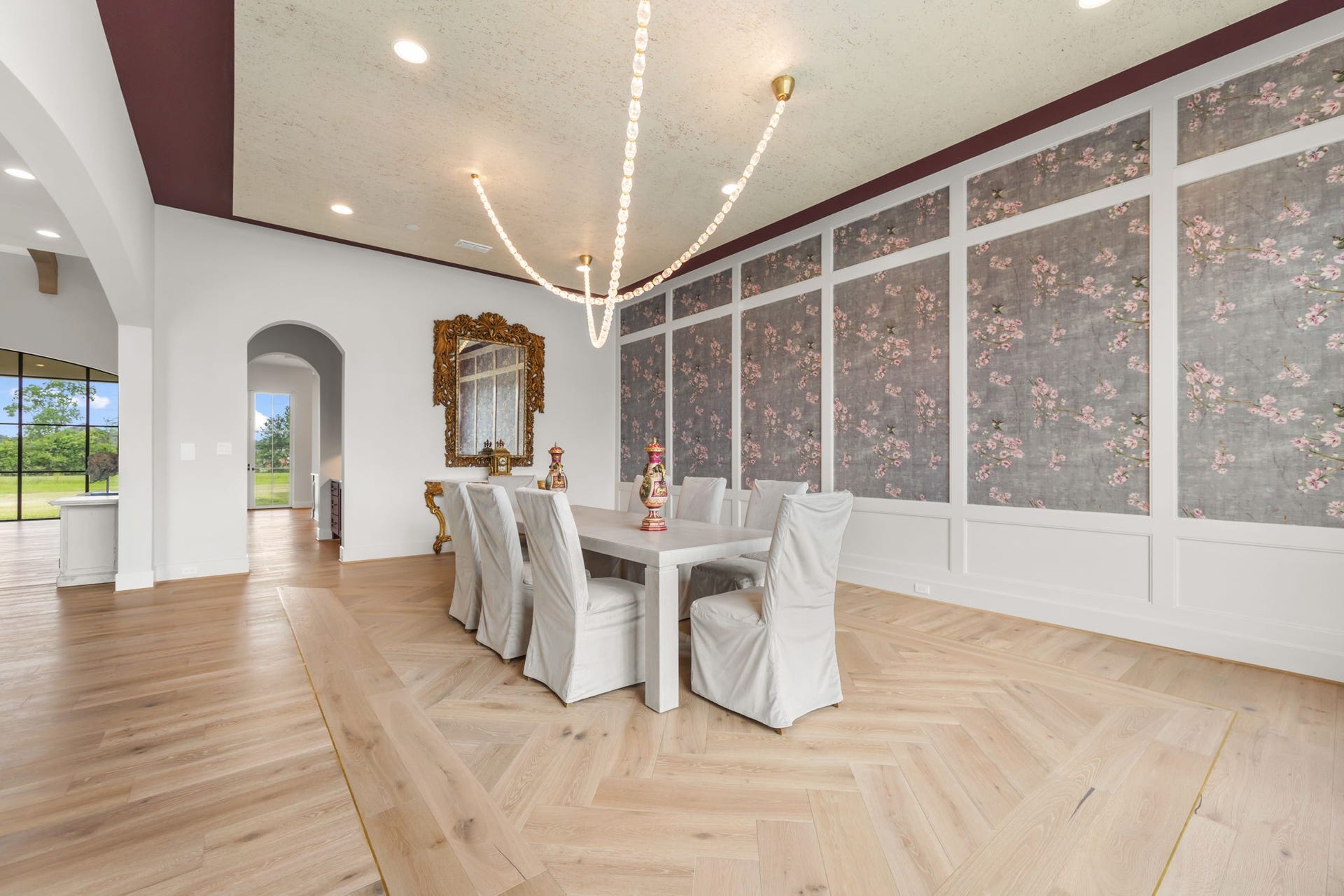 4233 Two Gun Way, Katy, TX 77494 Another view of formal dining room with unique rug design in hardwood floors framed by gold band which complement the crystal and gold accented light fixture.