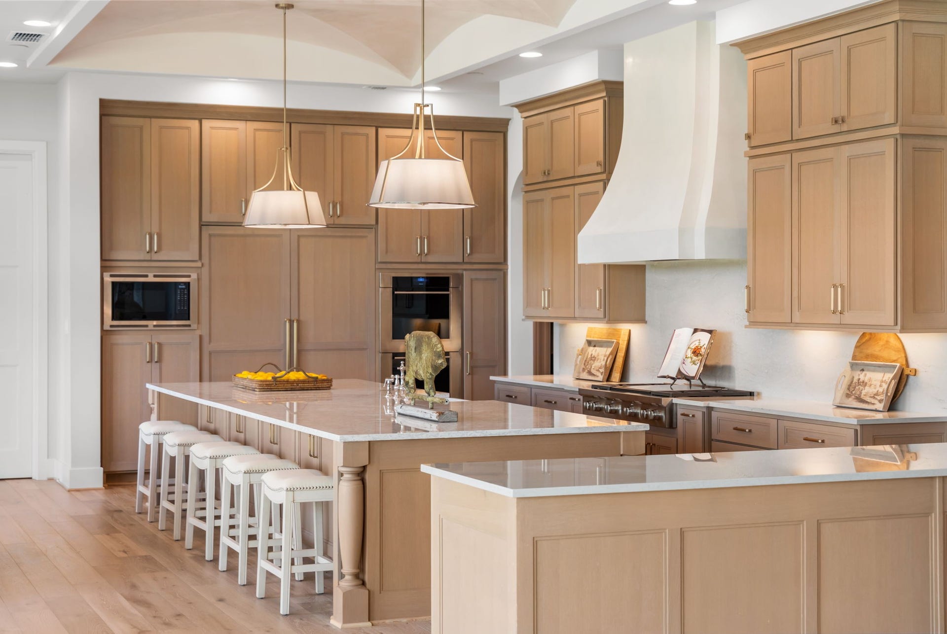 4233 Two Gun Way, Katy, TX 77494 Large island kitchen with Benedettini Cabinetry, quartz counter tops, stainless steel Sub Zero and Wolfe appliances including double ovens, microwave, two dishwashers, gas cook top with grill.
