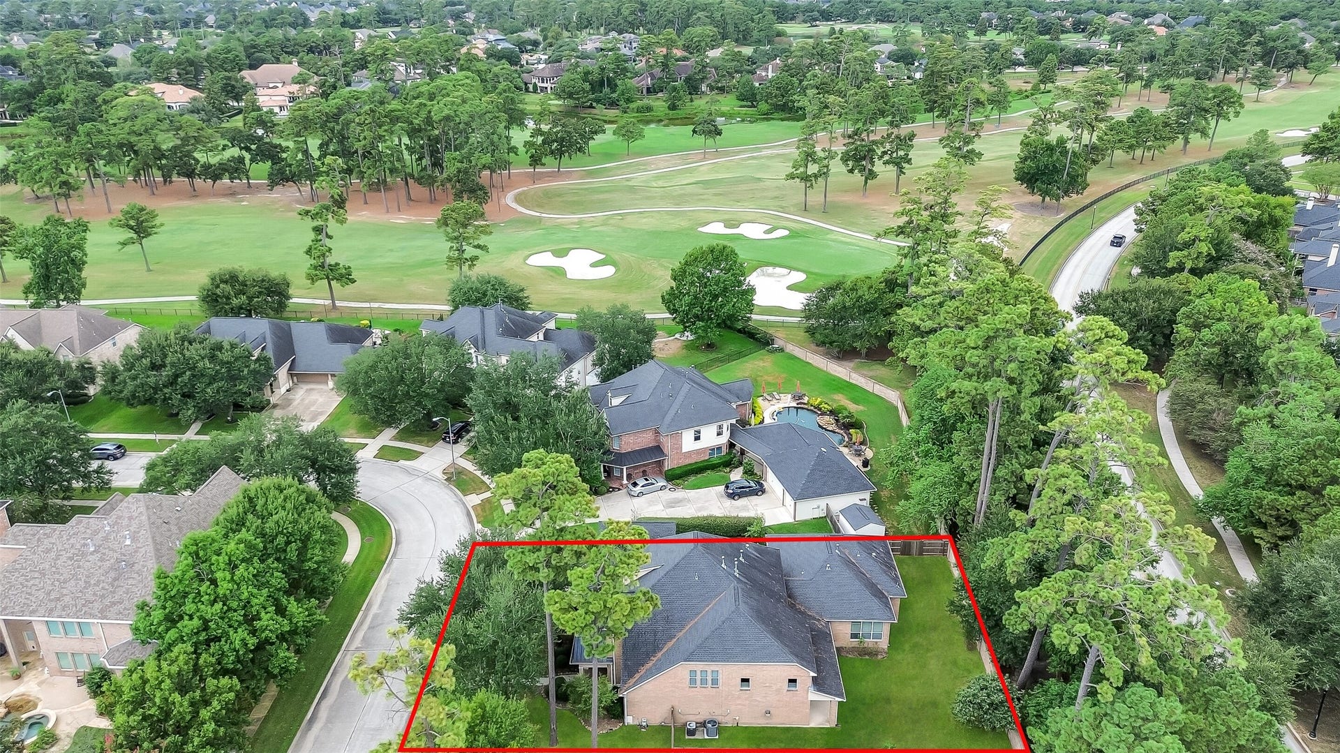 8407 Alyssa Gardens Lane, Humble, TX 77396 This aerial view highlights the home's proximity to the golf course. The wooded area directly behind the home runs along a walking trail, offering complete privacy with no rear neighbors.