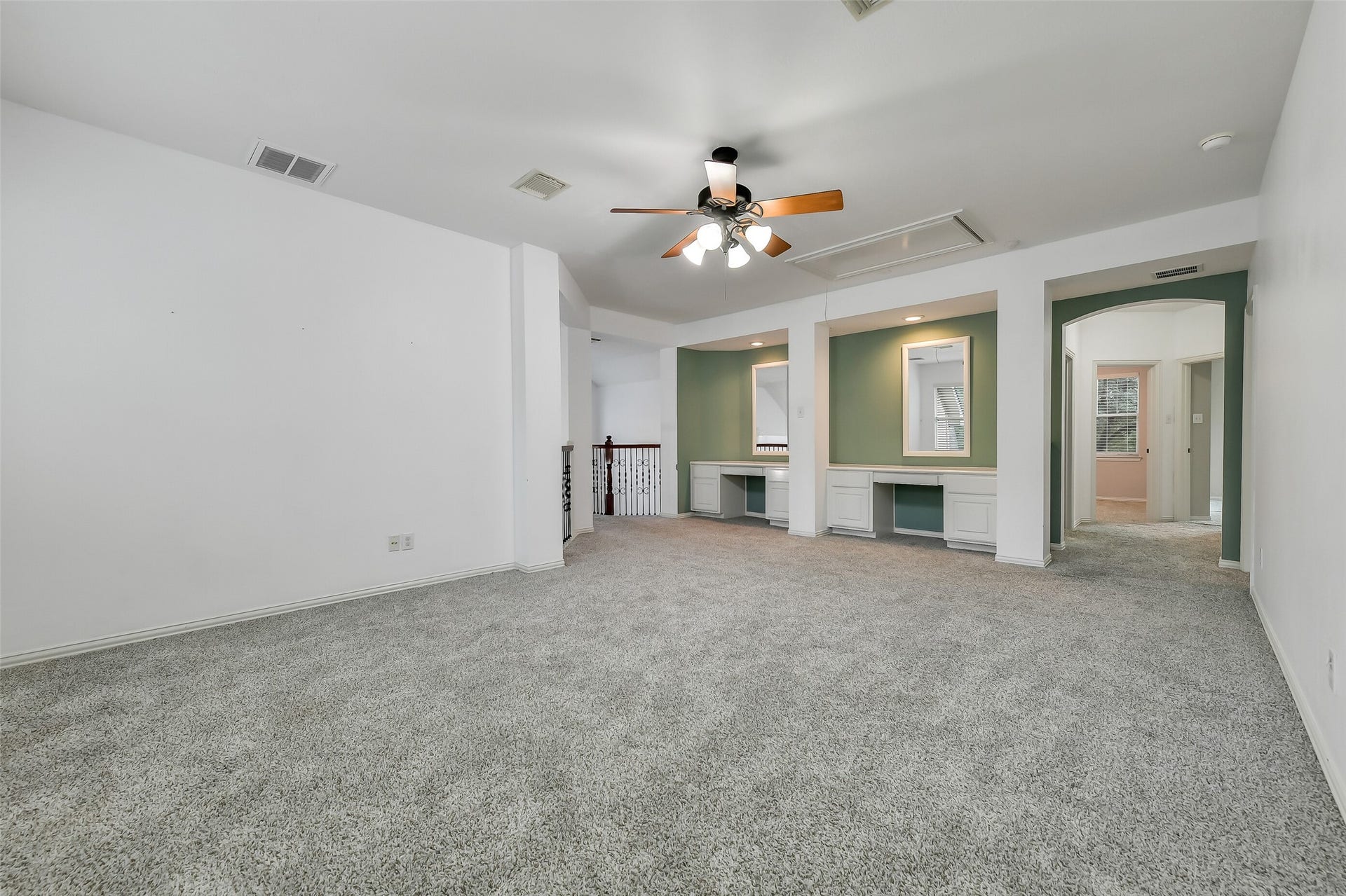 8407 Alyssa Gardens Lane, Humble, TX 77396 The spacious upstairs game room offers two built-in study areas for children, complete with an eye-catching accent wall.