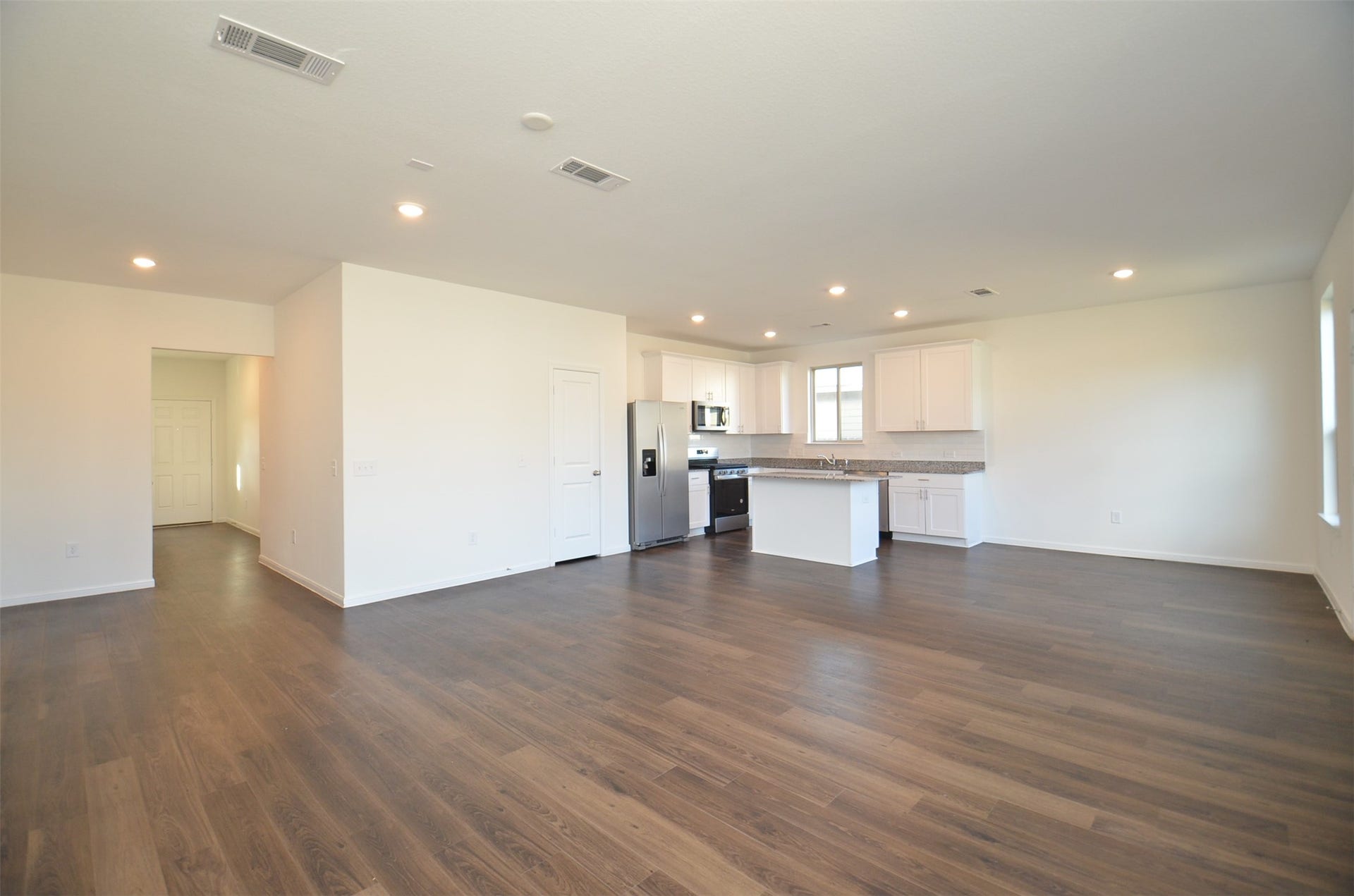 family room open concept layout flow to the kitchen