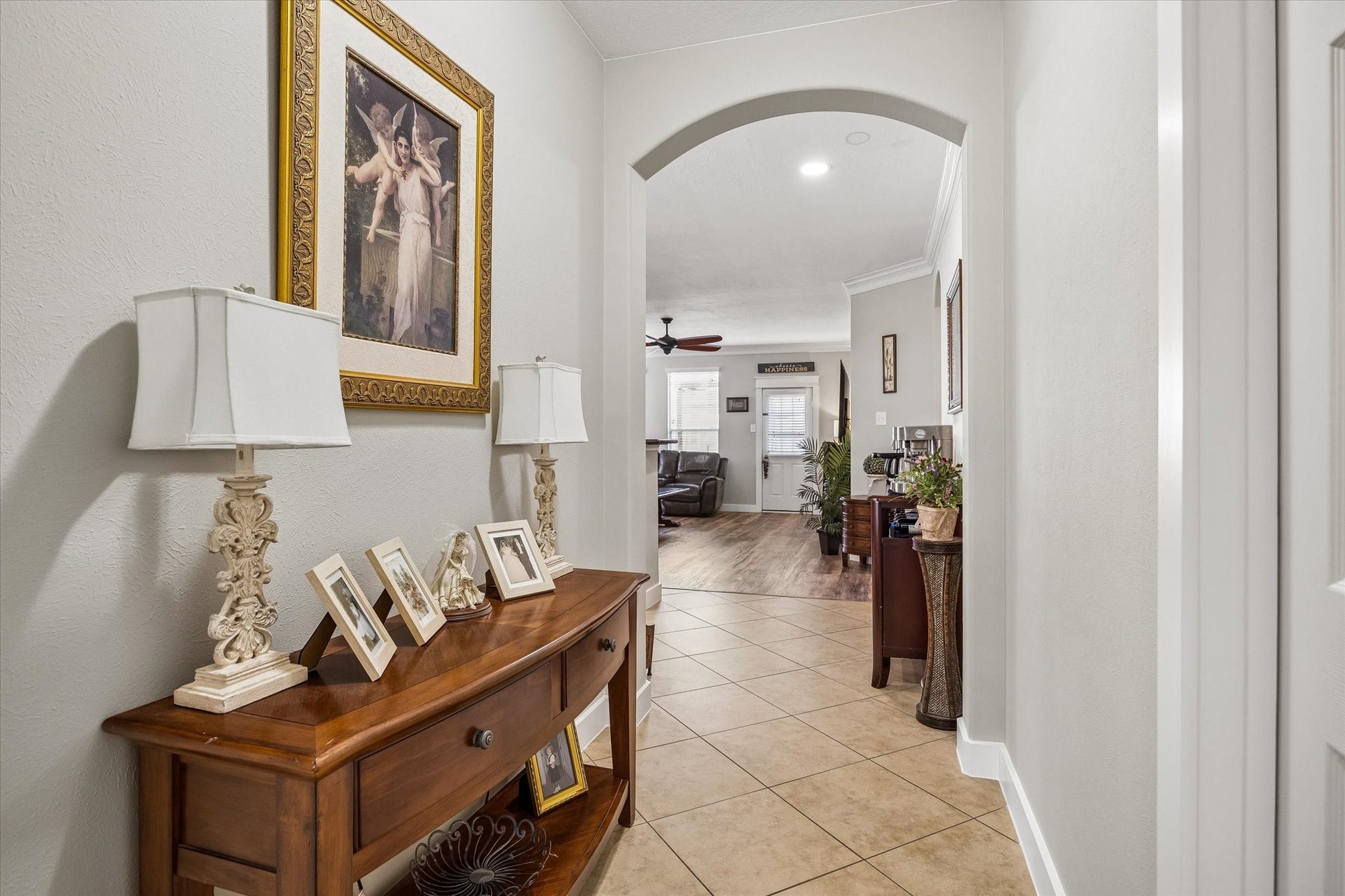 13918 Cypress Creek Bank Drive, Cypress, TX 77429 A welcoming entry hallway with arched openings and tile flooring creates an easy flow between the home's living spaces. Thoughtful architectural details add character throughout.