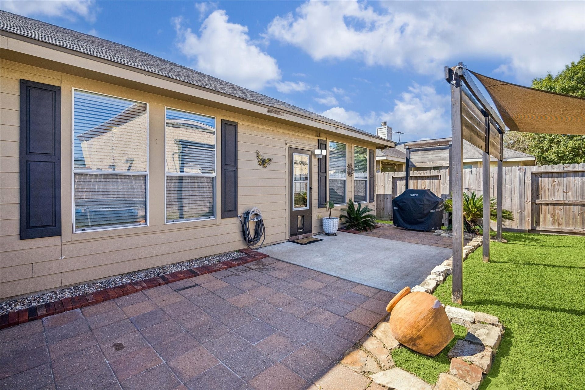 13918 Cypress Creek Bank Drive, Cypress, TX 77429 A generous patio extends the living space outdoors, offering room for seating, grilling, and entertaining. With easy access to the backyard and pergola, it's a great setup for weekend get-togethers or quiet evenings outside.