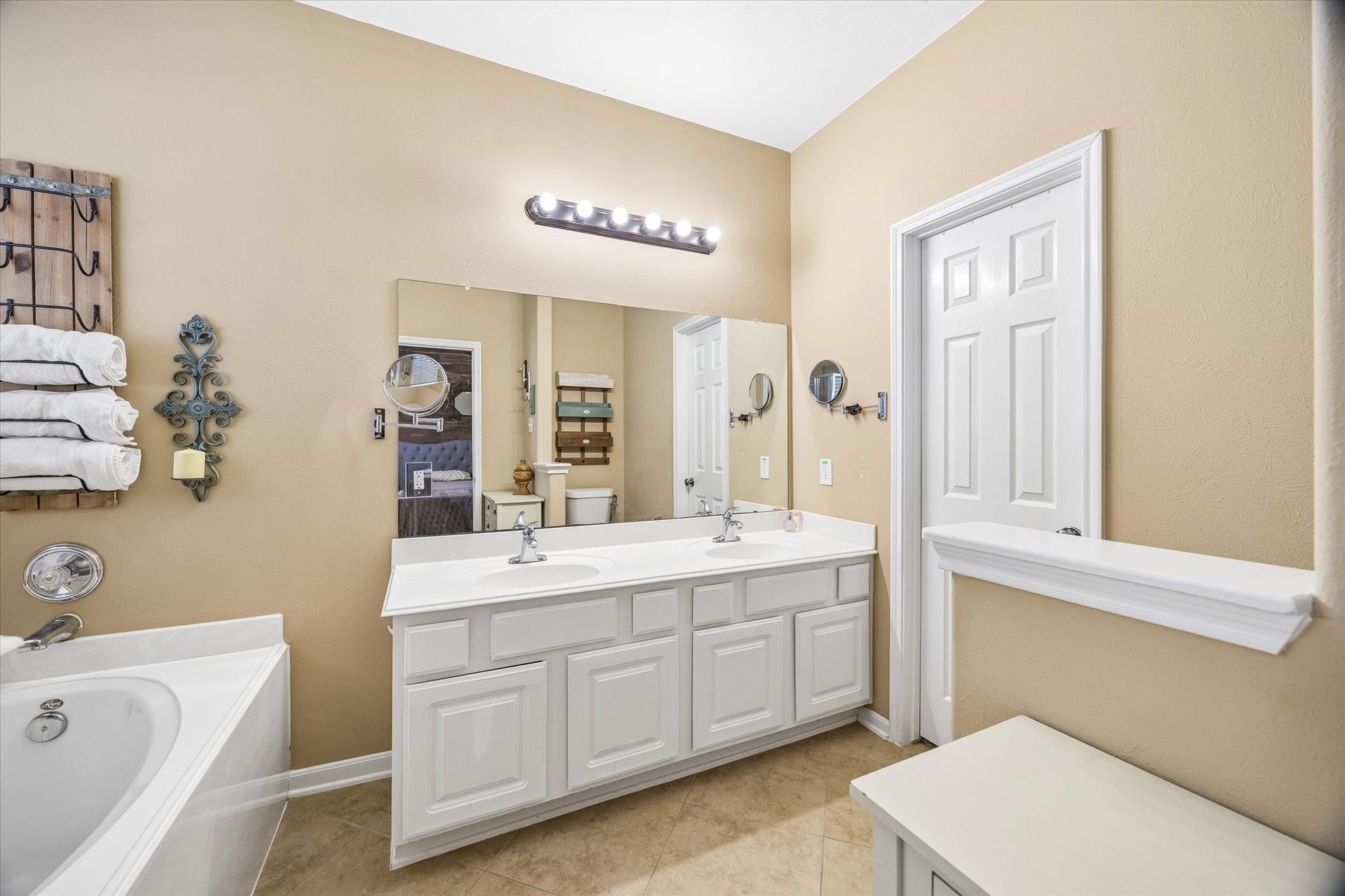 13918 Cypress Creek Bank Drive, Cypress, TX 77429 The primary bathroom features a spacious vanity with dual sinks, a soaking tub, and a separate shower. Natural light and neutral finishes create a comfortable space to start and end the day.