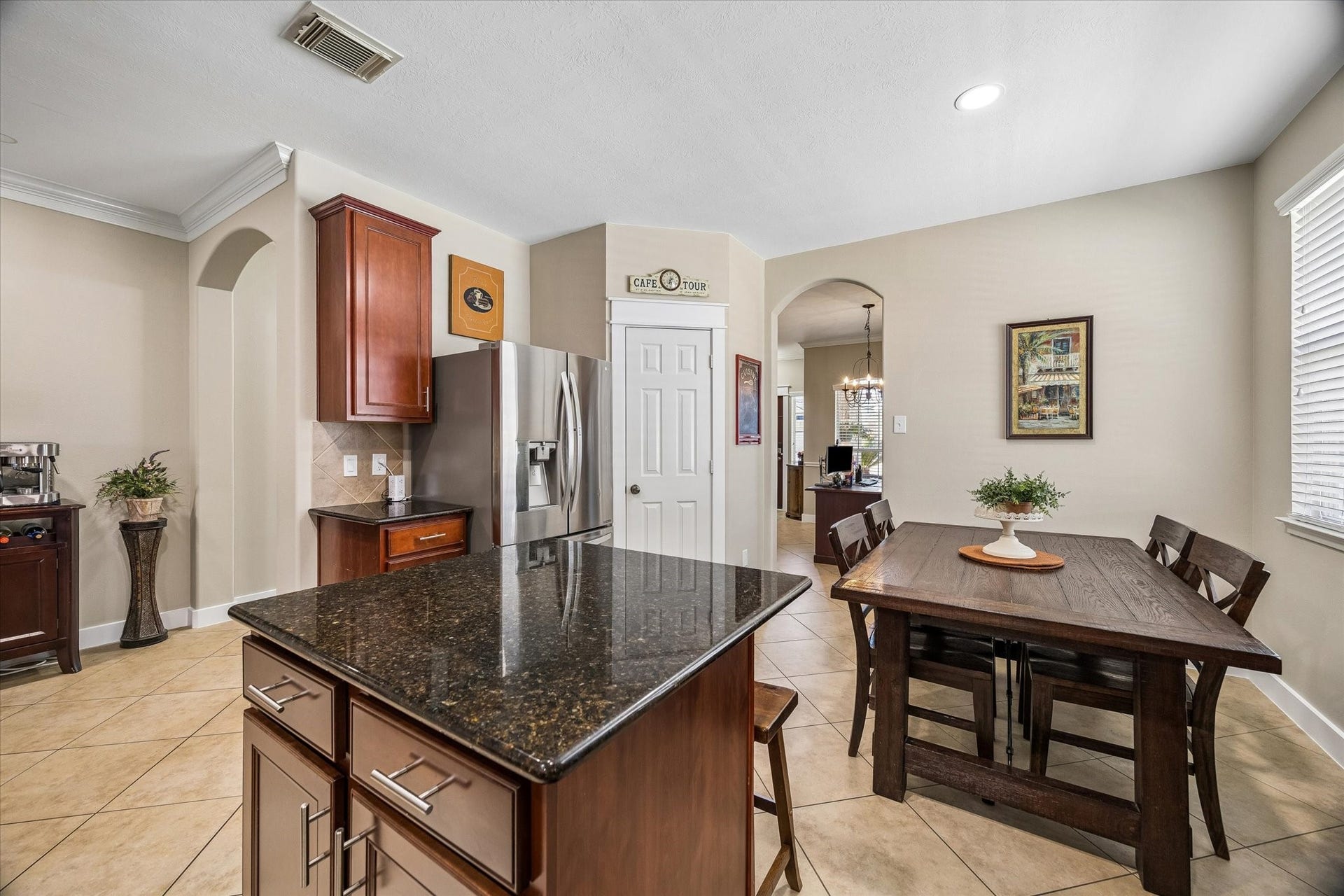 13918 Cypress Creek Bank Drive, Cypress, TX 77429 Another view of the kitchen highlights the generous counter space, center island, and open breakfast area. The layout keeps everything connected, whether you're cooking dinner or enjoying a quiet morning at home.
