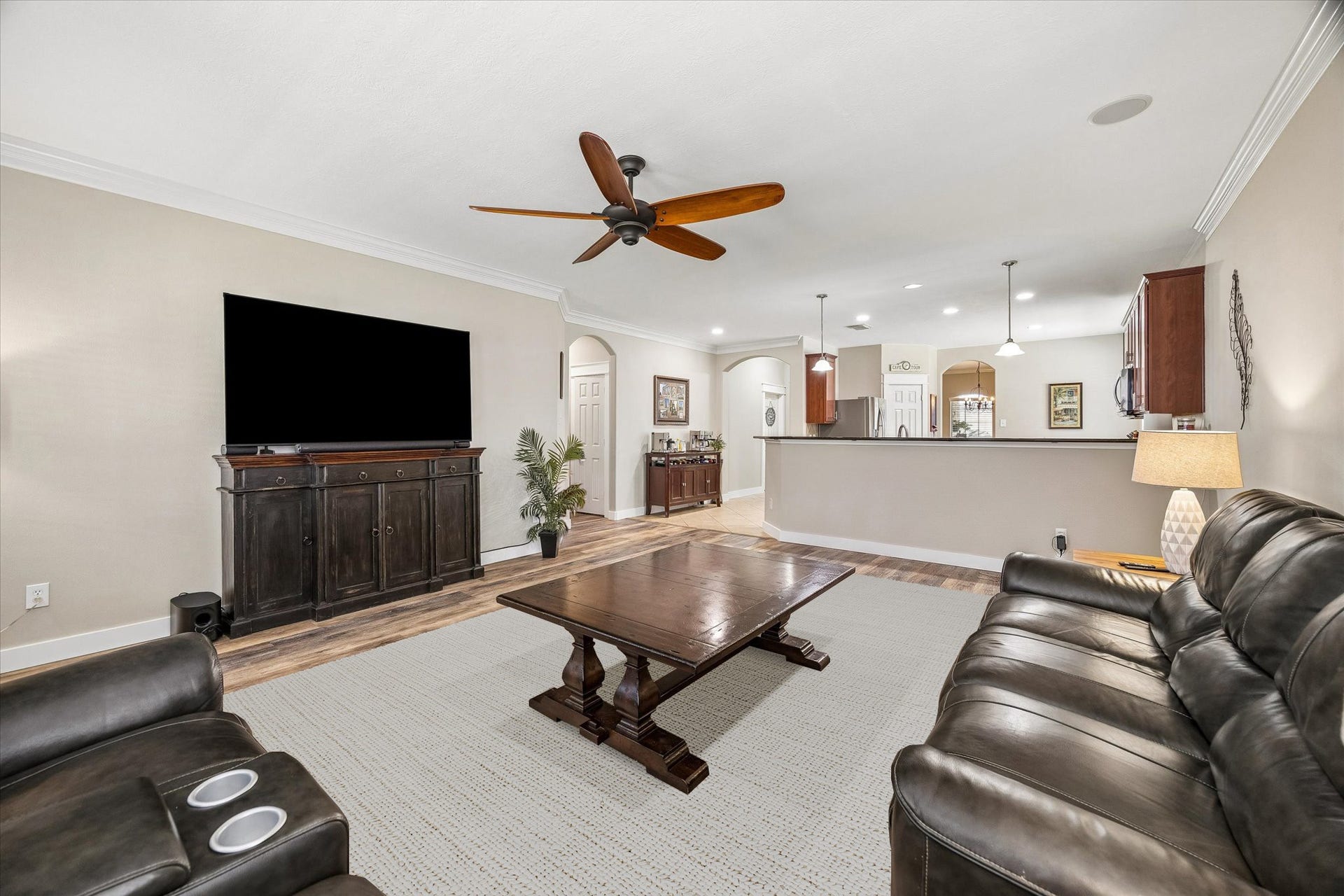 13918 Cypress Creek Bank Drive, Cypress, TX 77429 The family room offers plenty of space to relax or entertain, with warm wood-look flooring and a ceiling fan. Its open layout creates a comfortable setting for movie nights, family gatherings, or simply unwinding at home.