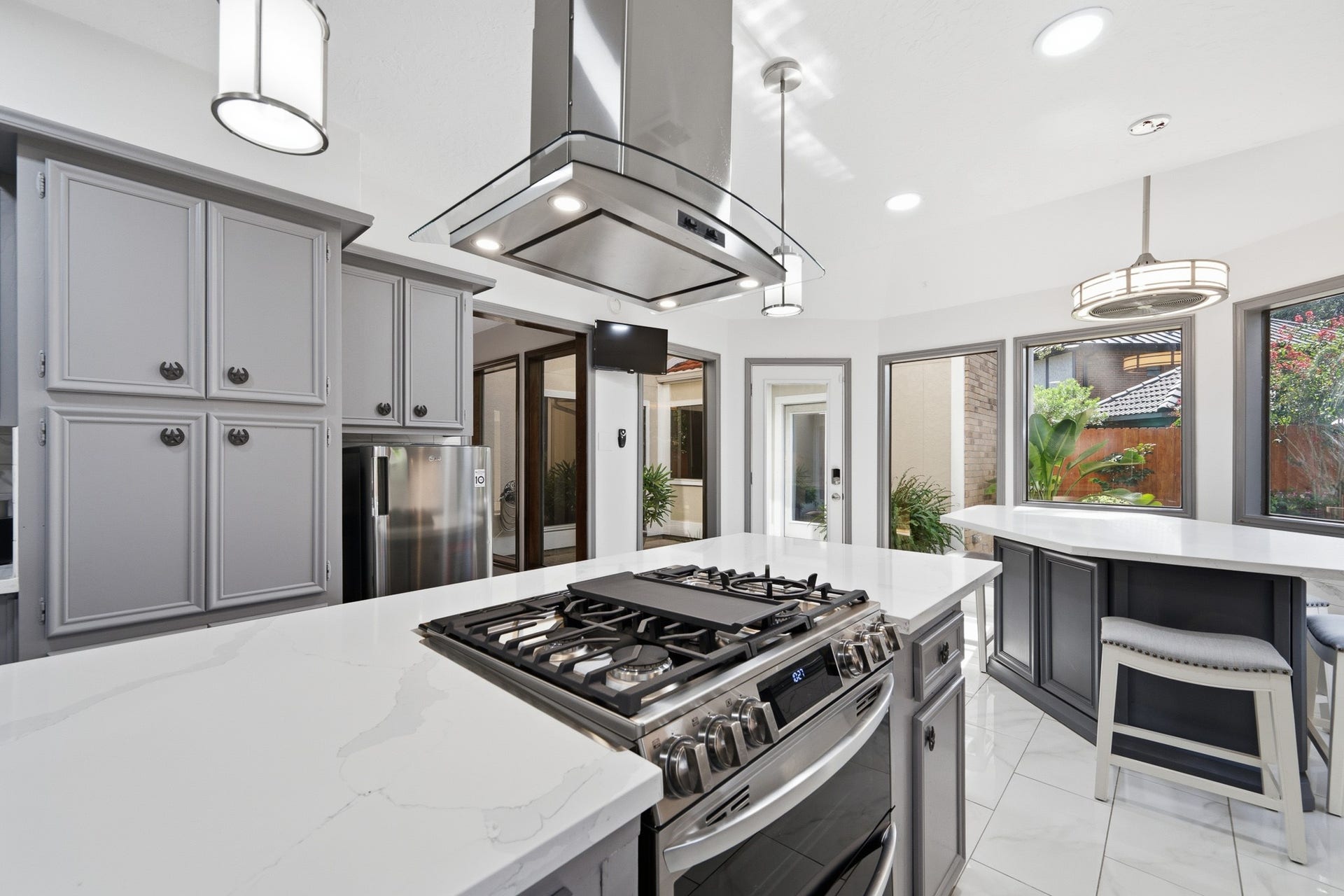 Additional kitchen view showcasing ample cabinetry, generous counter space, and casual bar seating.