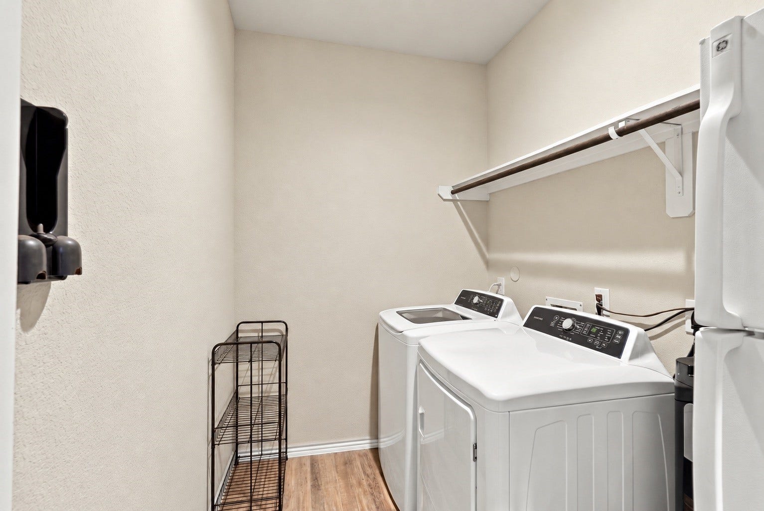 18042 Atwood Mill Drive, New Caney, TX 77357 Laundry Room
Dedicated laundry room with washer and dryer, overhead hanging/storage space, and additional room for organization. - Virtually Decluttered