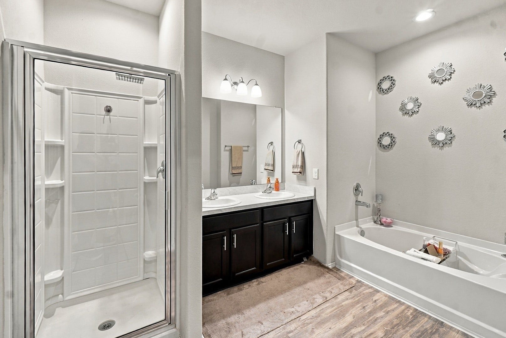 18042 Atwood Mill Drive, New Caney, TX 77357 Primary bathroom features a dual-sink vanity, separate soaking tub, and walk-in shower.