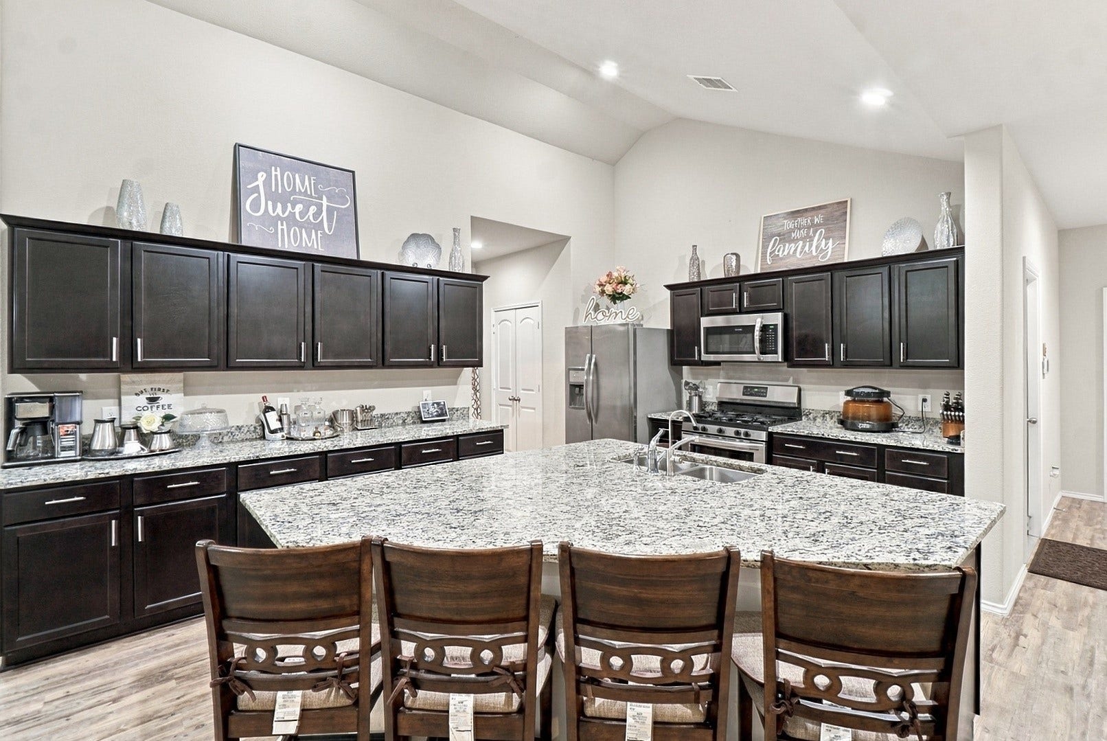 18042 Atwood Mill Drive, New Caney, TX 77357 Another view highlighting the kitchen's abundant cabinet and counter space, stainless steel appliances, and impressive center island.