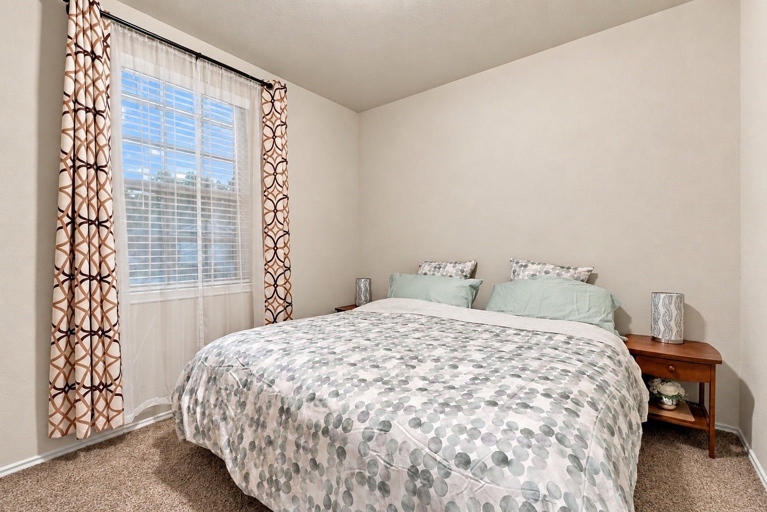 18042 Atwood Mill Drive, New Caney, TX 77357 Comfortable secondary bedroom featuring neutral finishes, carpet, and a large window providing natural light.
