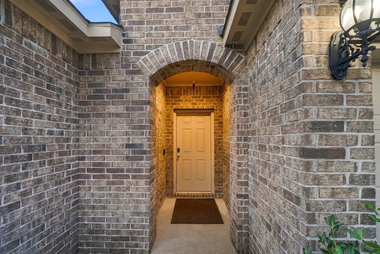18042 Atwood Mill Drive, New Caney, TX 77357 Covered front entry framed by an attractive brick archway welcomes you inside.