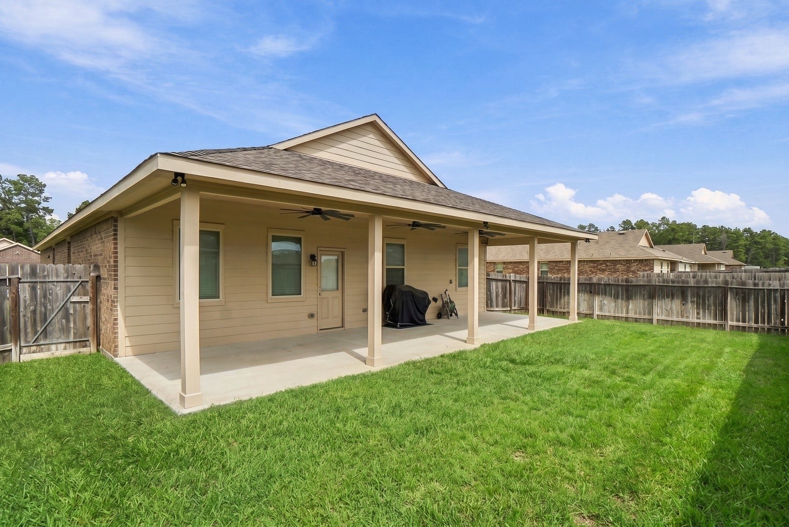 18042 Atwood Mill Drive, New Caney, TX 77357 Another view of the generously sized covered patio offering an expansive outdoor area with room for seating, dining, grilling, and entertaining.