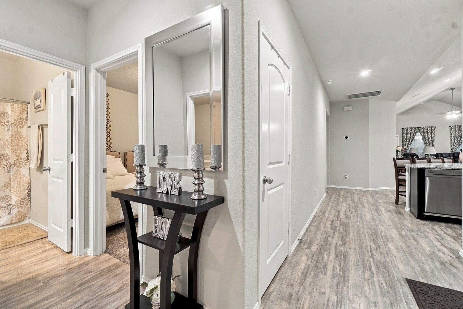 18042 Atwood Mill Drive, New Caney, TX 77357 Step inside to an inviting interior with neutral tones, durable wood-look laminate flooring, and an open layout leading toward the main living areas.