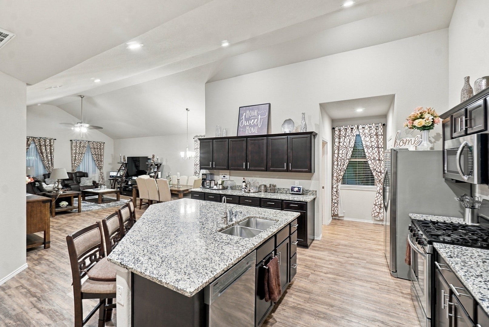 18042 Atwood Mill Drive, New Caney, TX 77357 Spacious kitchen with abundant cabinetry, granite countertops, stainless steel appliances, recessed lighting, and an oversized island.