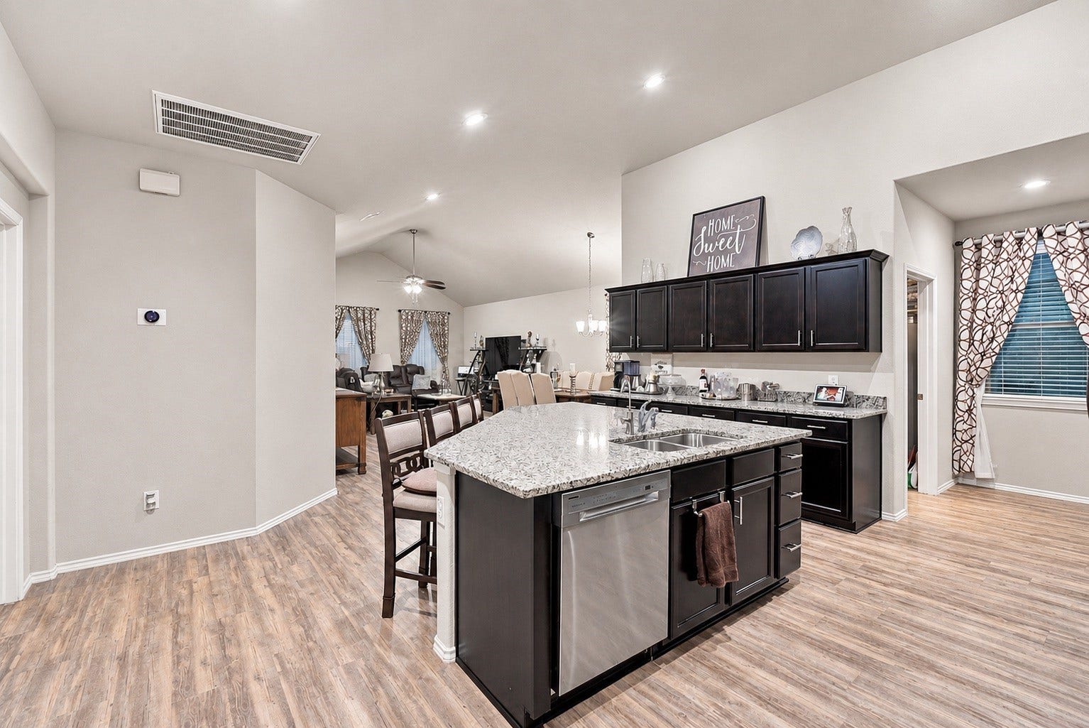 18042 Atwood Mill Drive, New Caney, TX 77357 The open-concept kitchen serves as the heart of the home, featuring a large granite island and seamless connection to the dining and living areas.