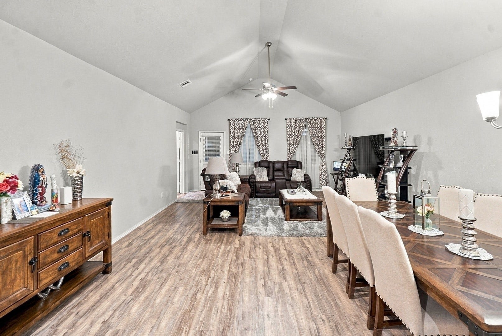 18042 Atwood Mill Drive, New Caney, TX 77357 Open-concept living and dining areas offer plenty of room for everyday living and entertaining beneath a vaulted ceiling.