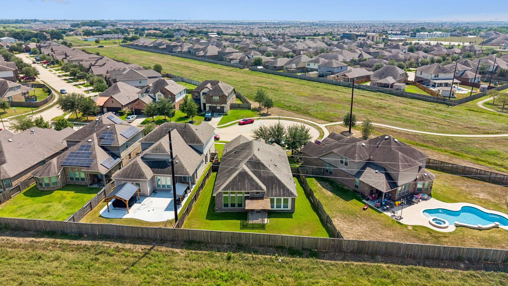 5107 Baroness Lane, Katy, TX 77493 Aerial view of a charming cul-de-sac neighborhood featuring spacious backyards, against a lush greenbelt for added privacy of no back neighbors on a private street.