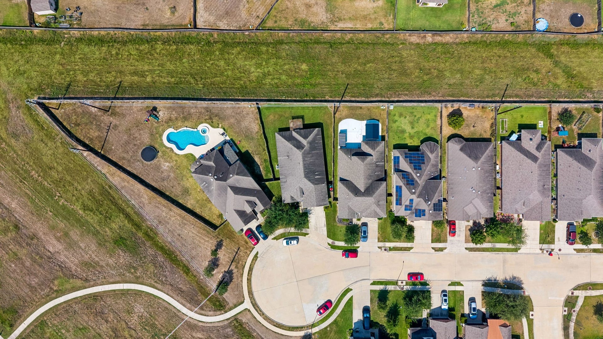 5107 Baroness Lane, Katy, TX 77493 Aerial view of a charming cul-de-sac neighborhood featuring spacious backyards, against a lush greenbelt for added privacy of no back neighbors on a private street.